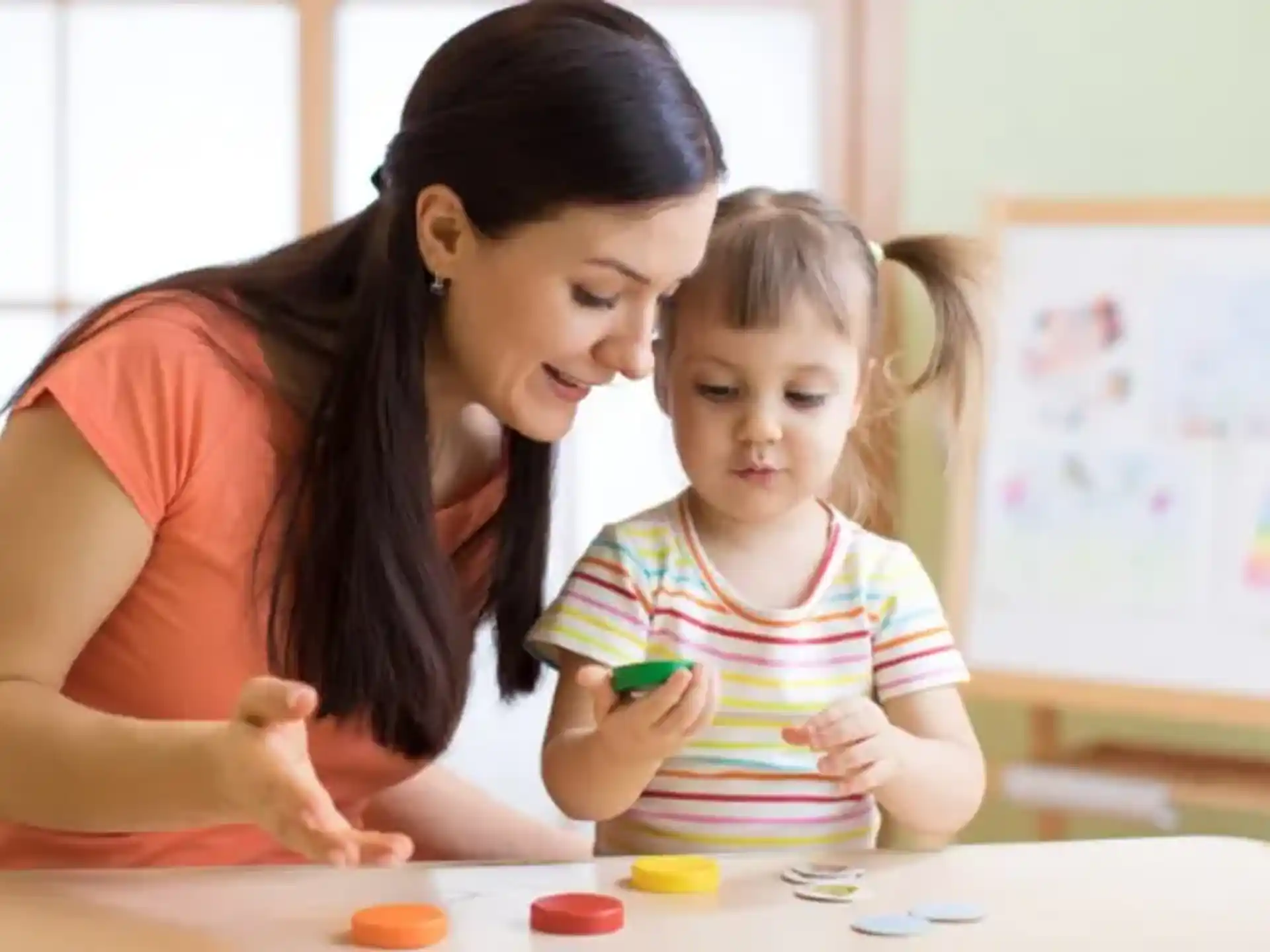 a person and a child playing with toys