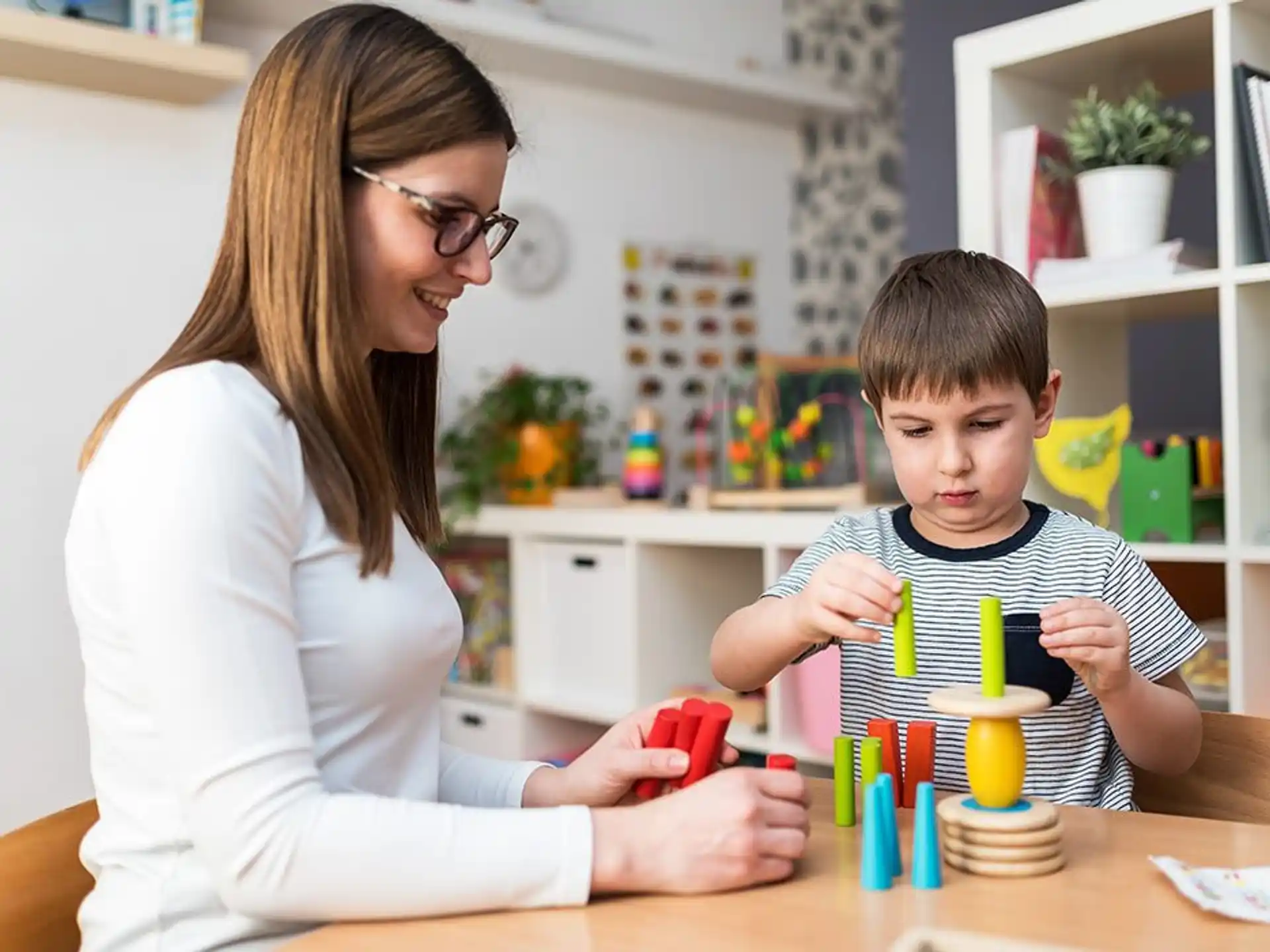 a woman and a boy playing with toys