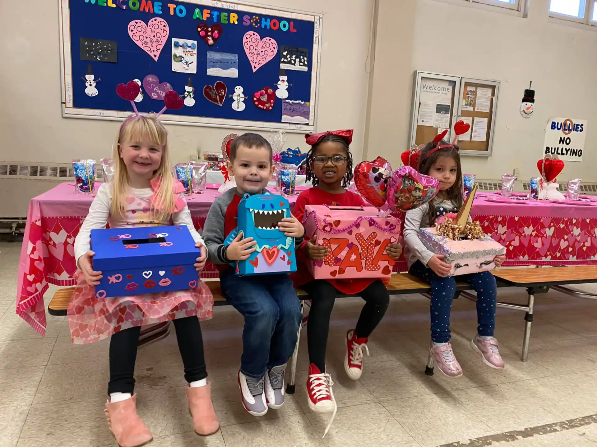 a group of children holding up a gift box