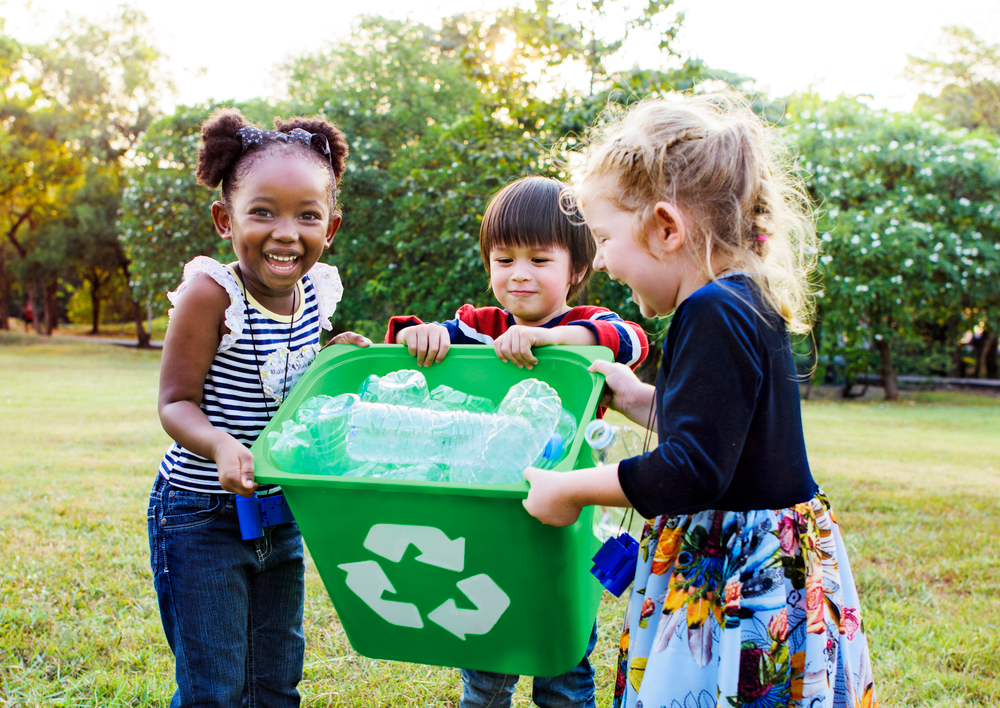 a group of children holding a bucket
