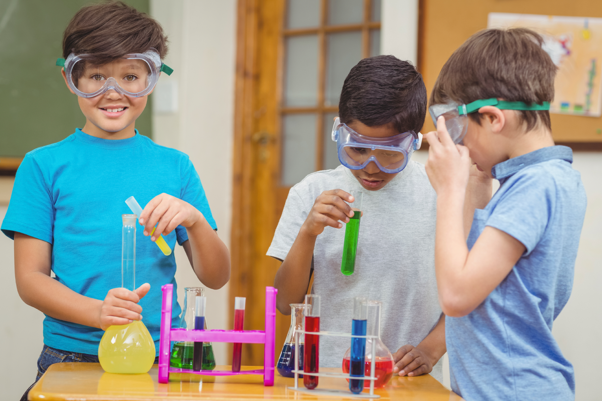 a group of kids wearing safety goggles and holding colored pencils