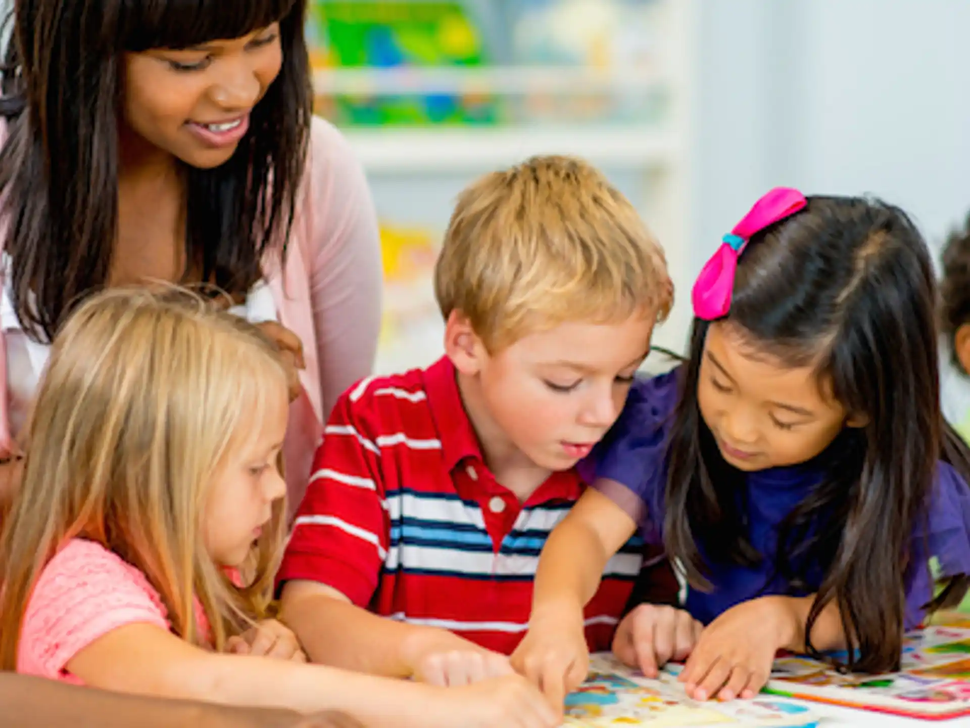 a person and several children looking at a map