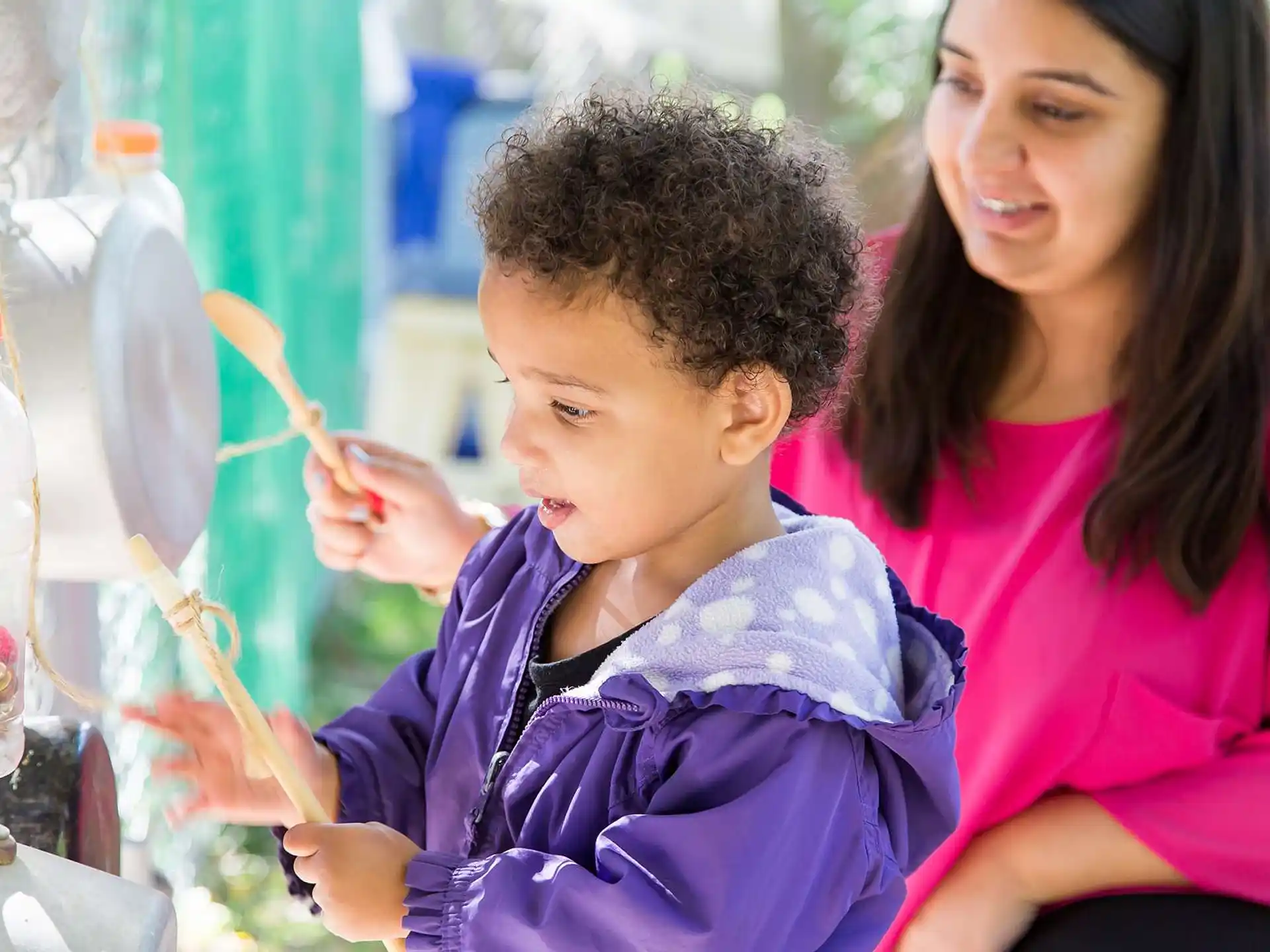 a person and a child looking at a test tube