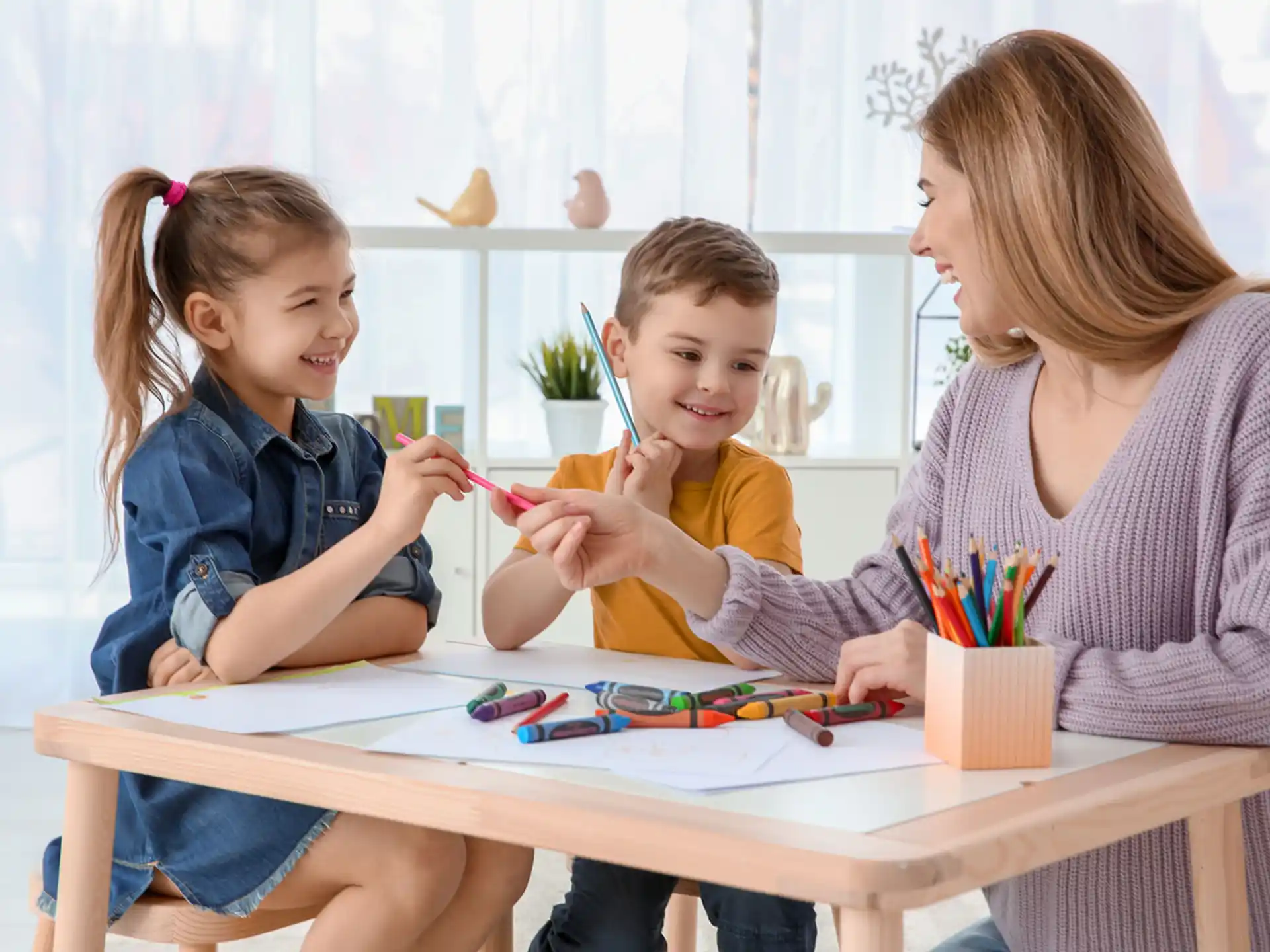 a person and two children sitting at a table