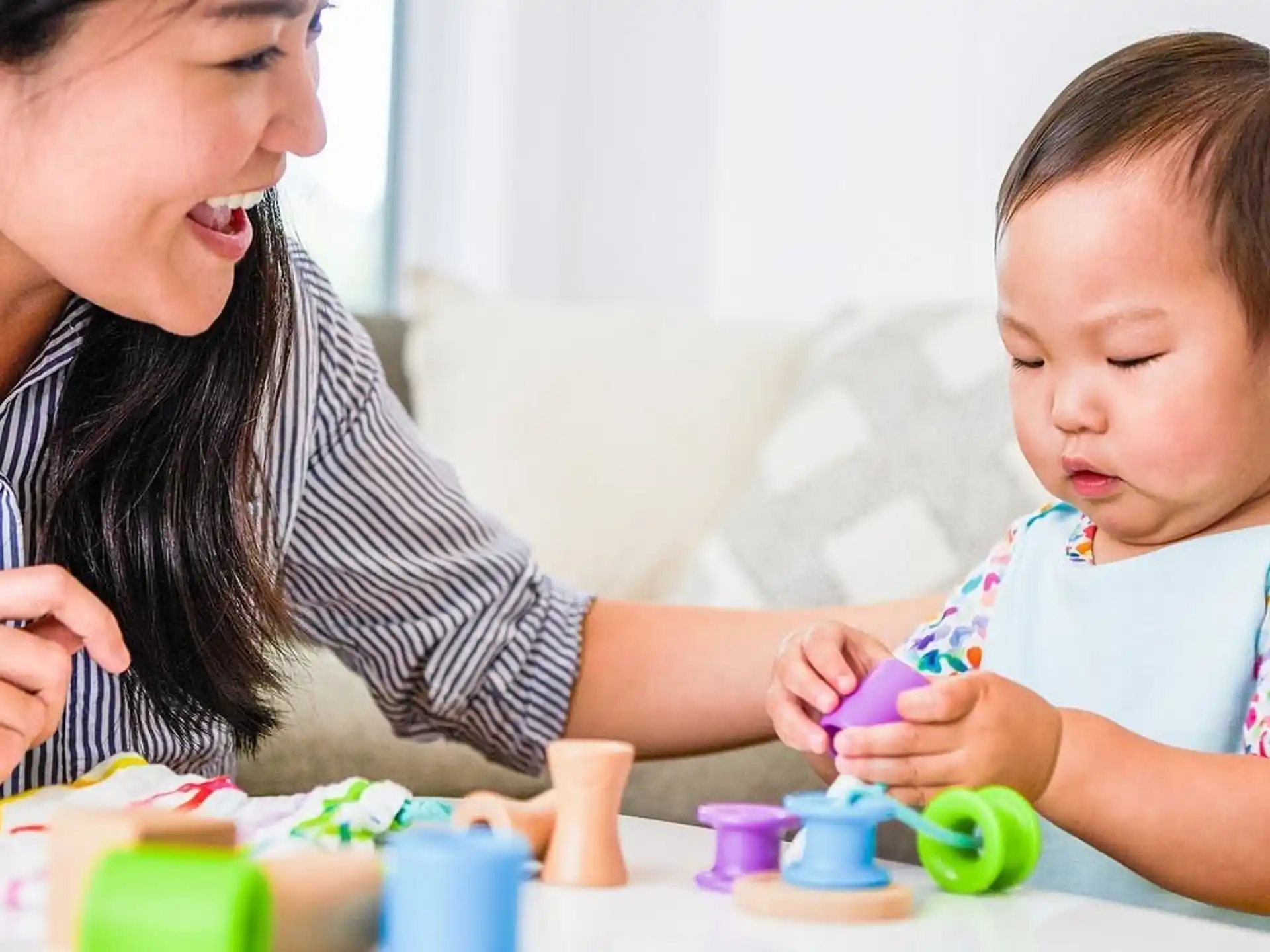 a person and a child playing with toys