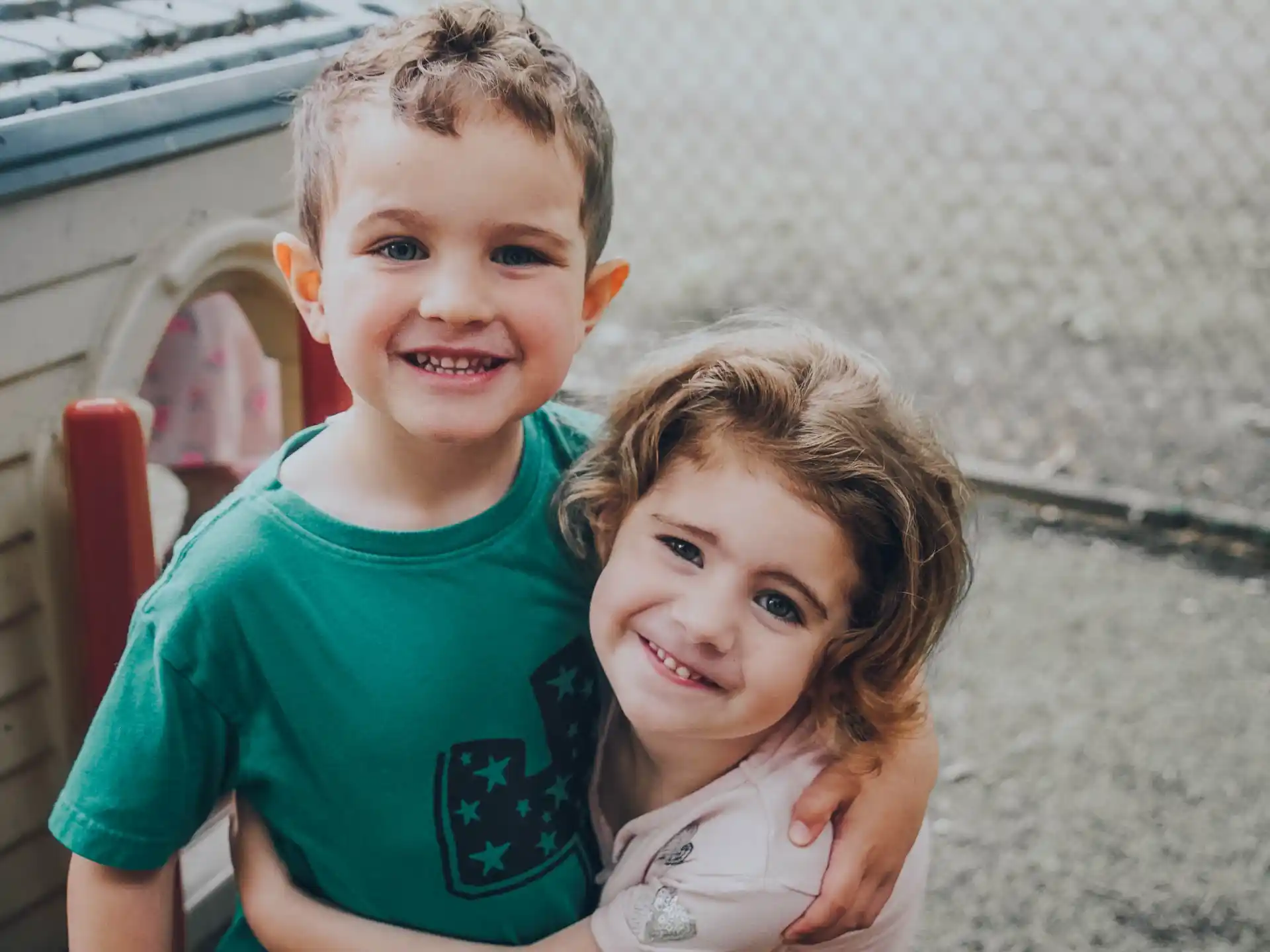 a boy and girl posing for a picture