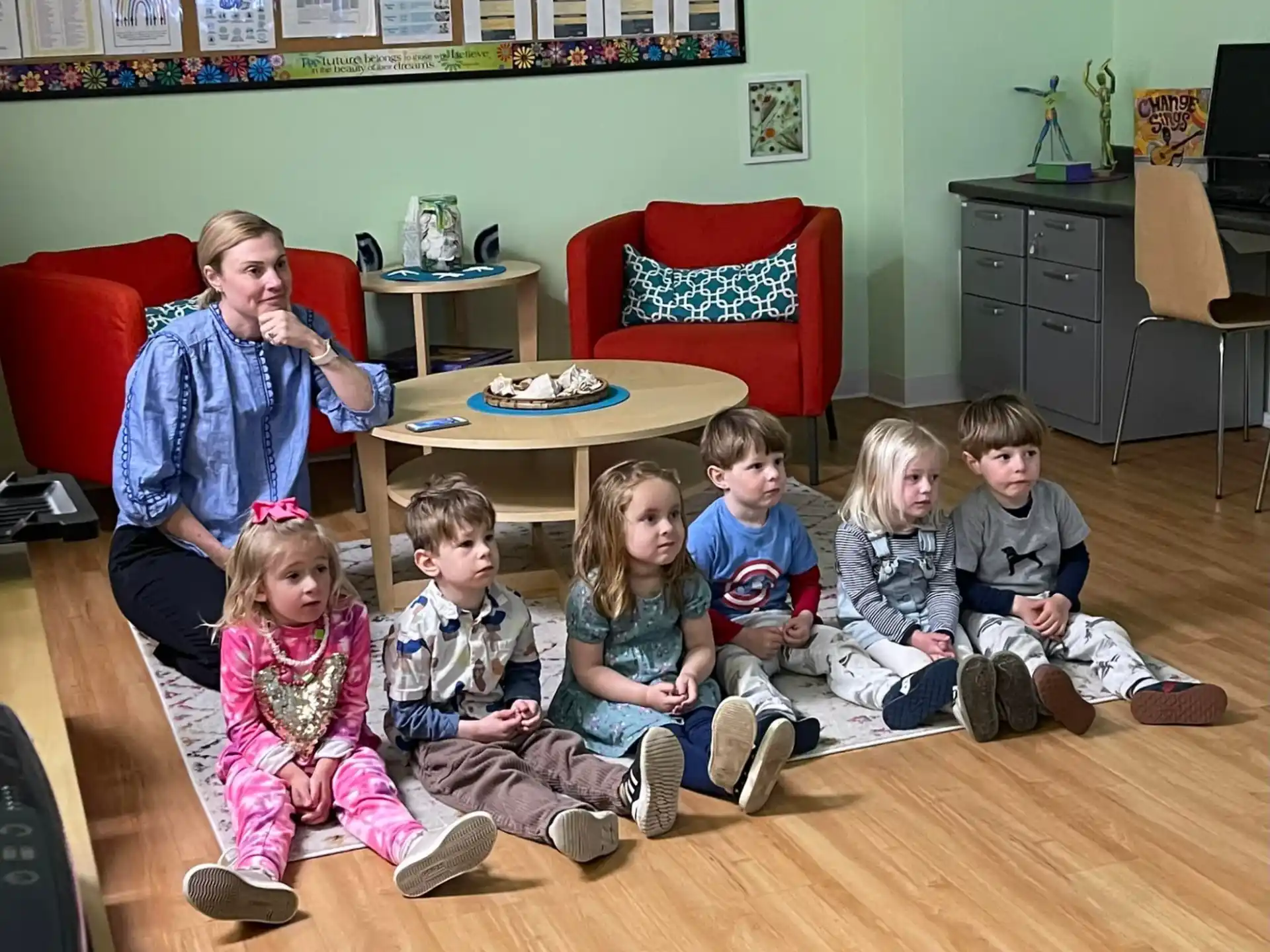 a group of children sitting on the floor