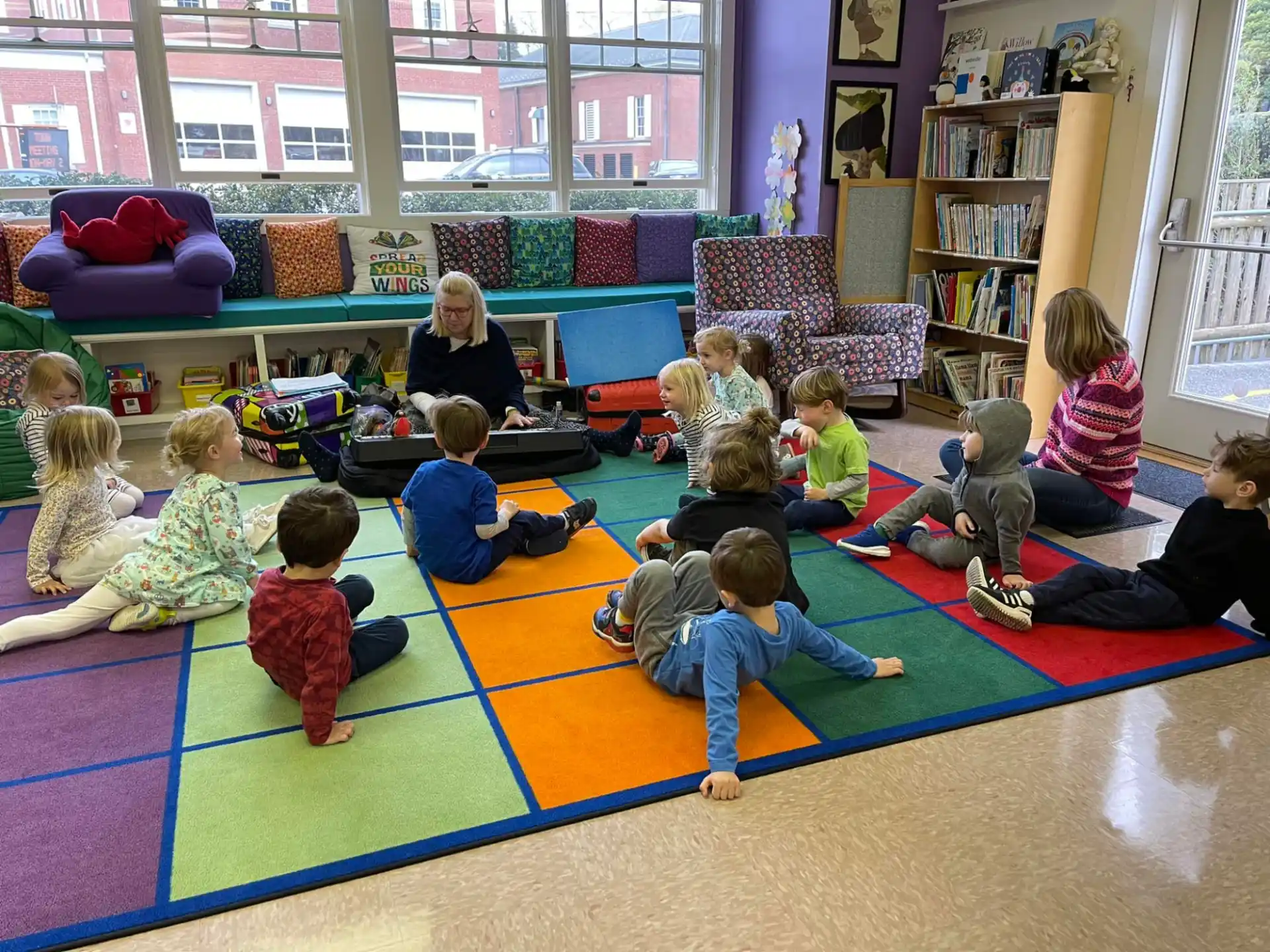 a group of children sitting on the floor in a room