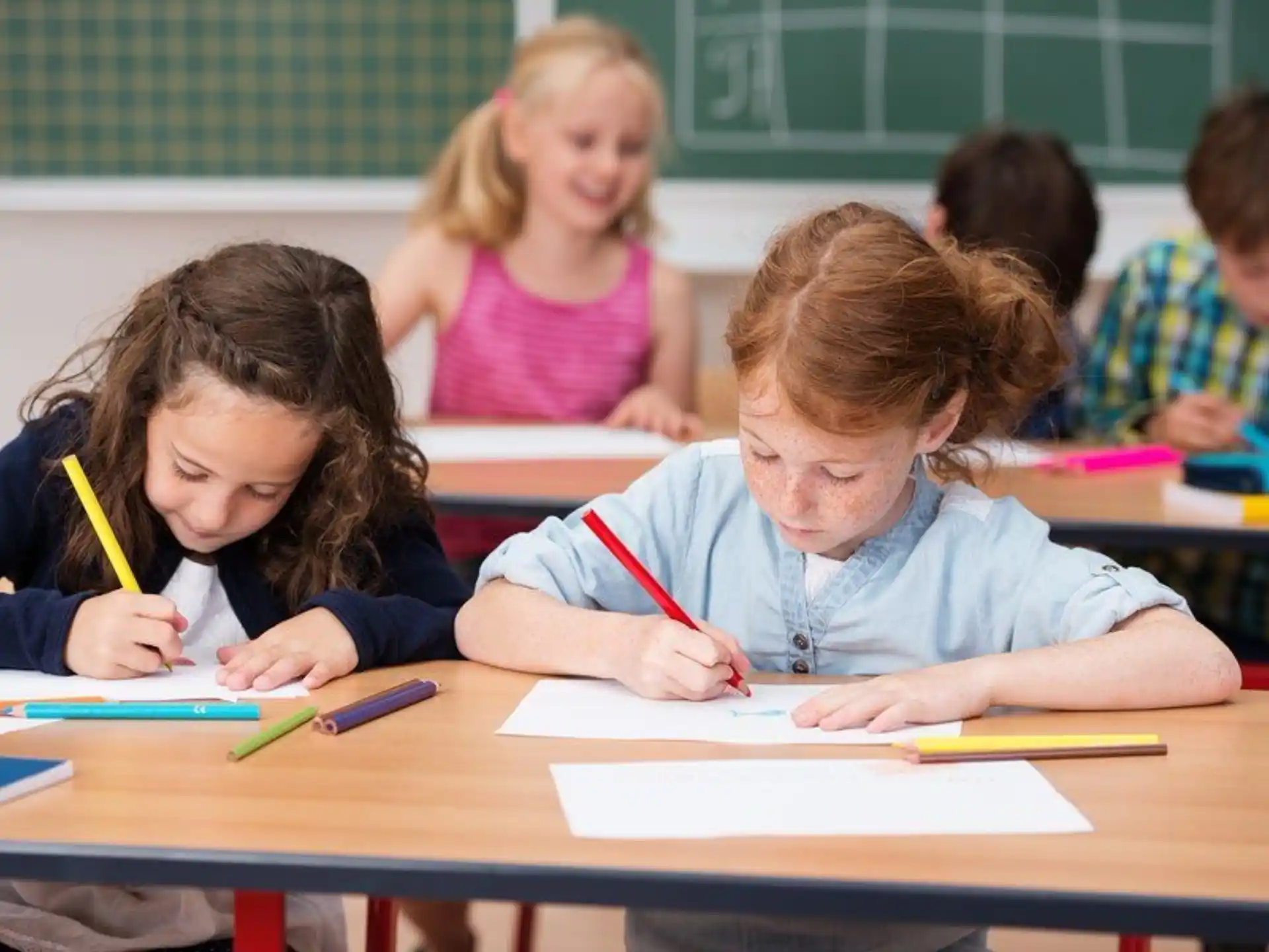 a few children sitting at desks