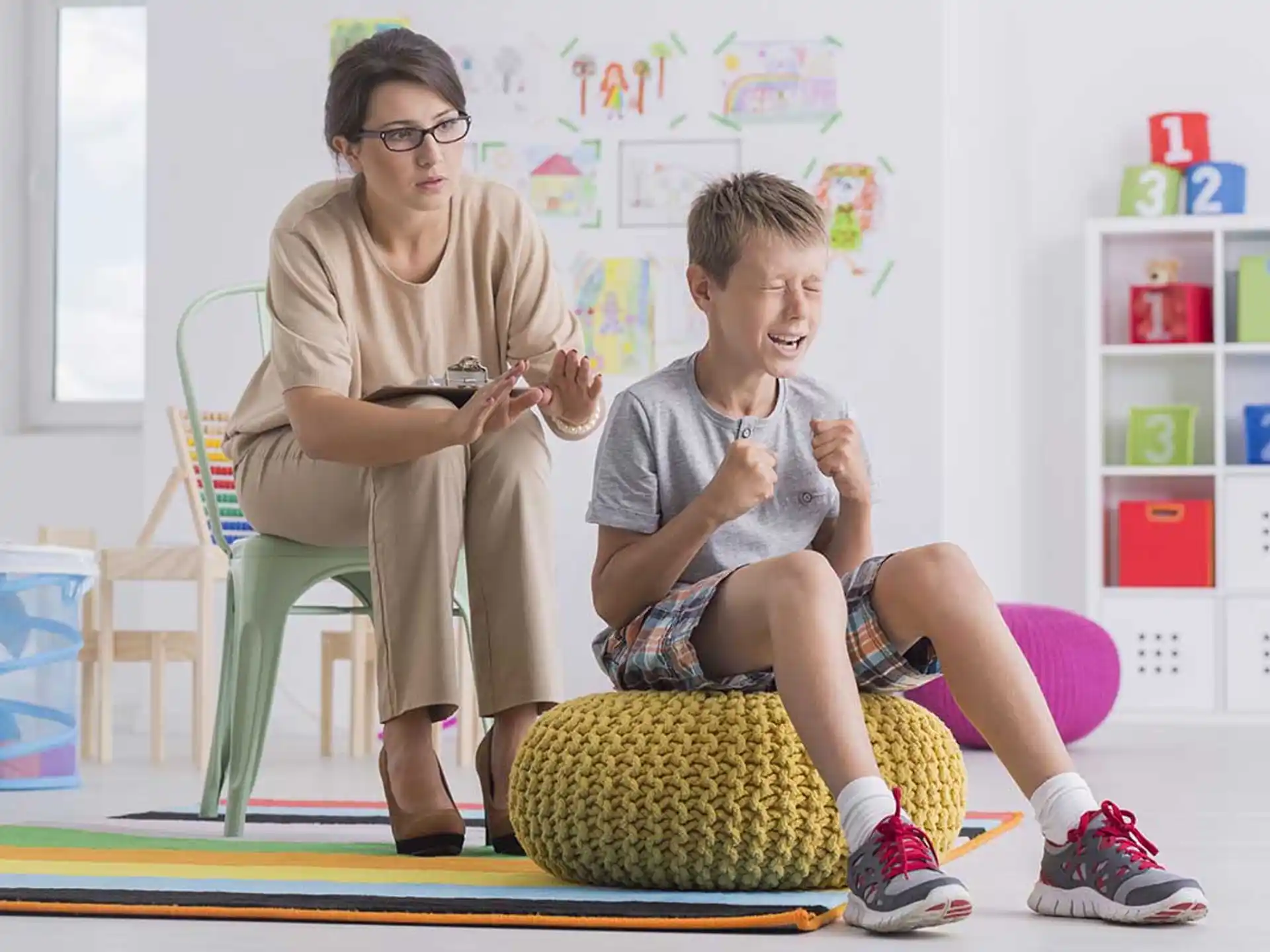 a person and a boy sitting on a chair