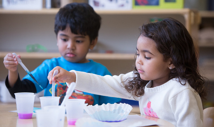 a young boy and girl painting