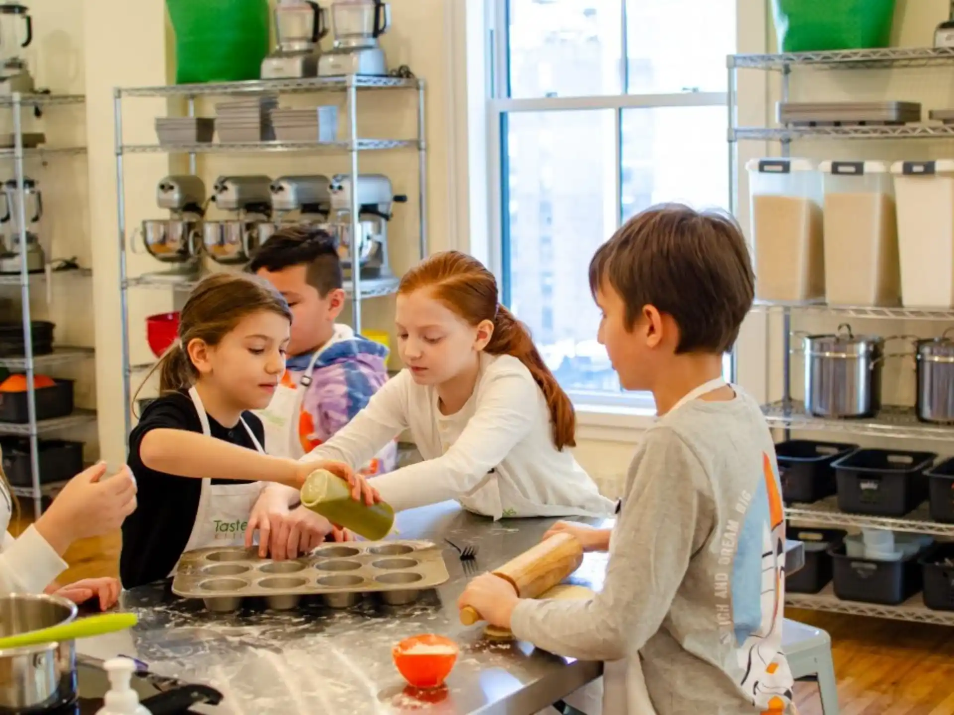 a group of people cooking in a kitchen