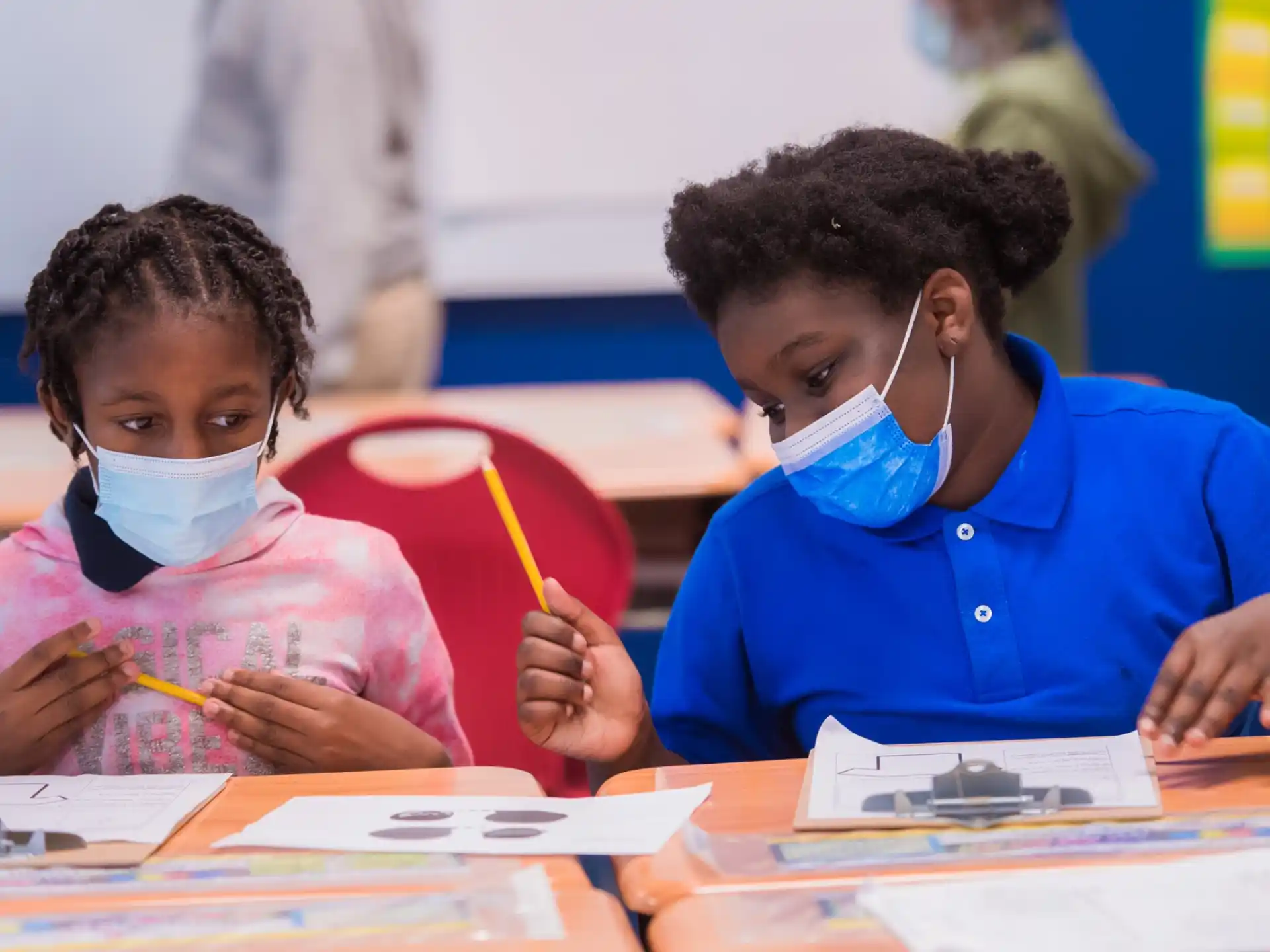 a few young children wearing masks