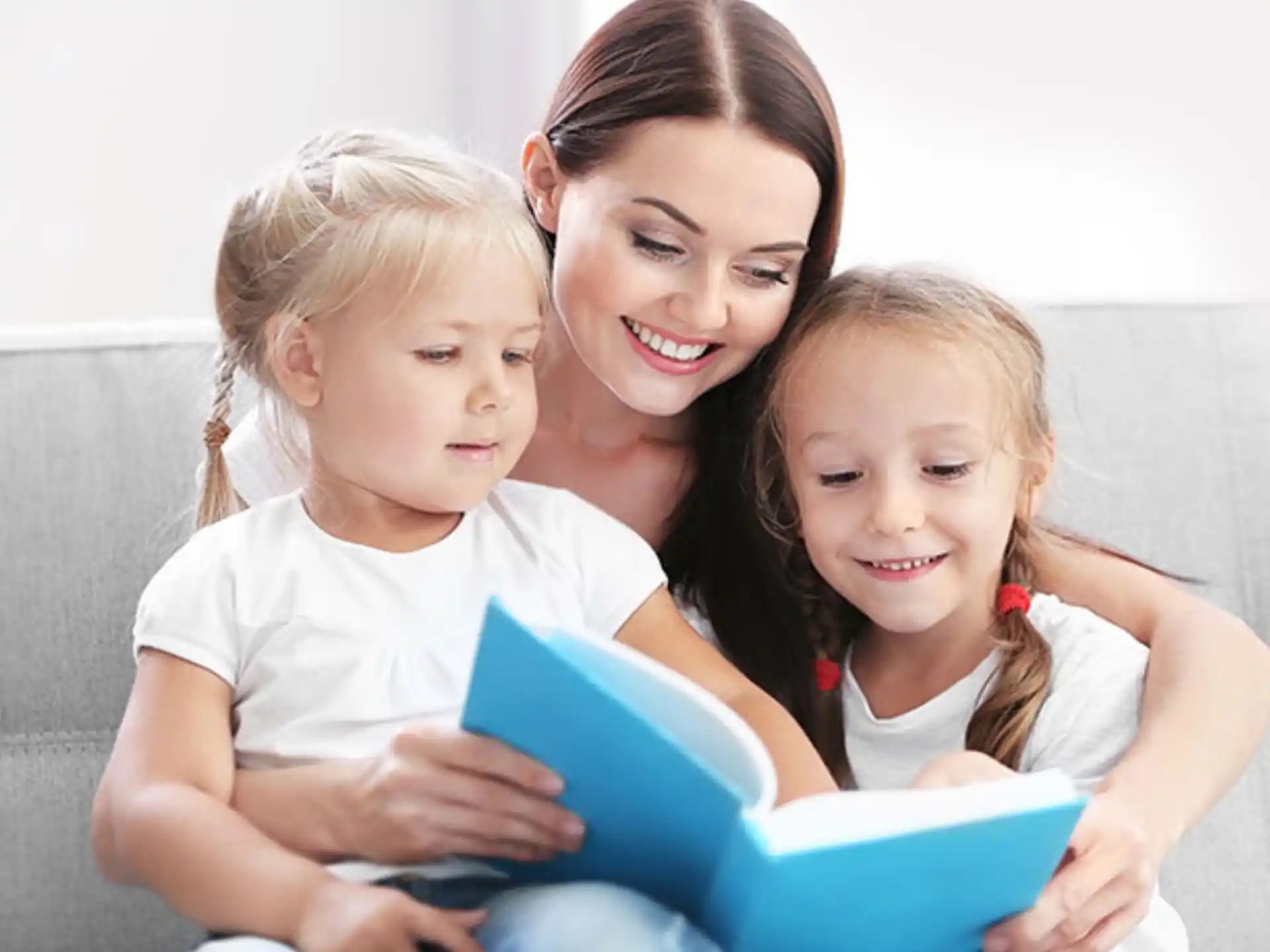 a person and two children looking at a laptop