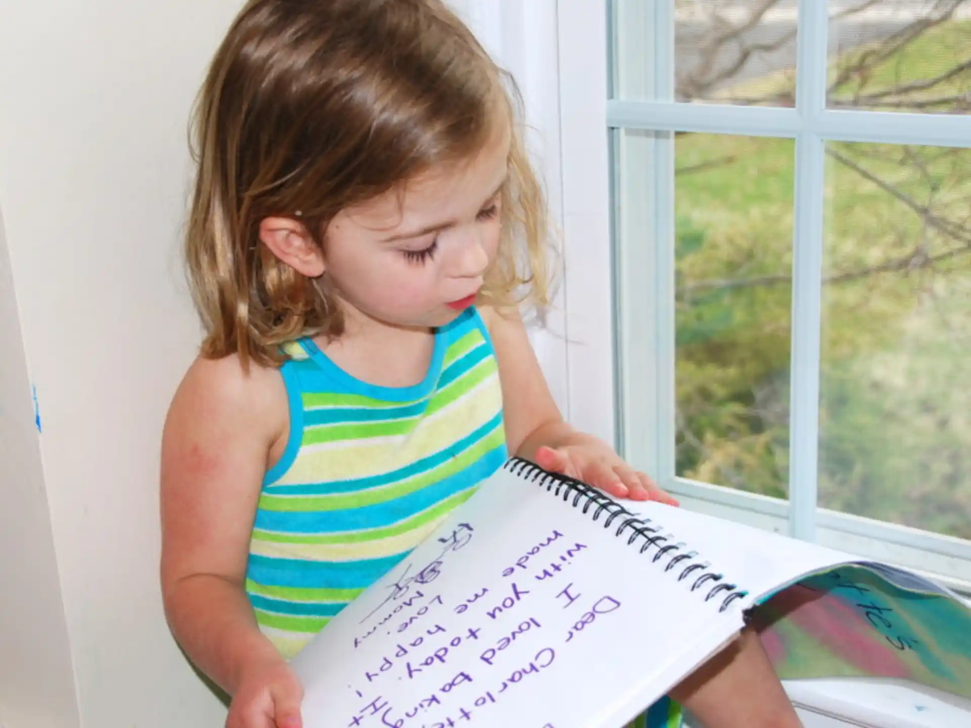 a girl holding a piece of paper