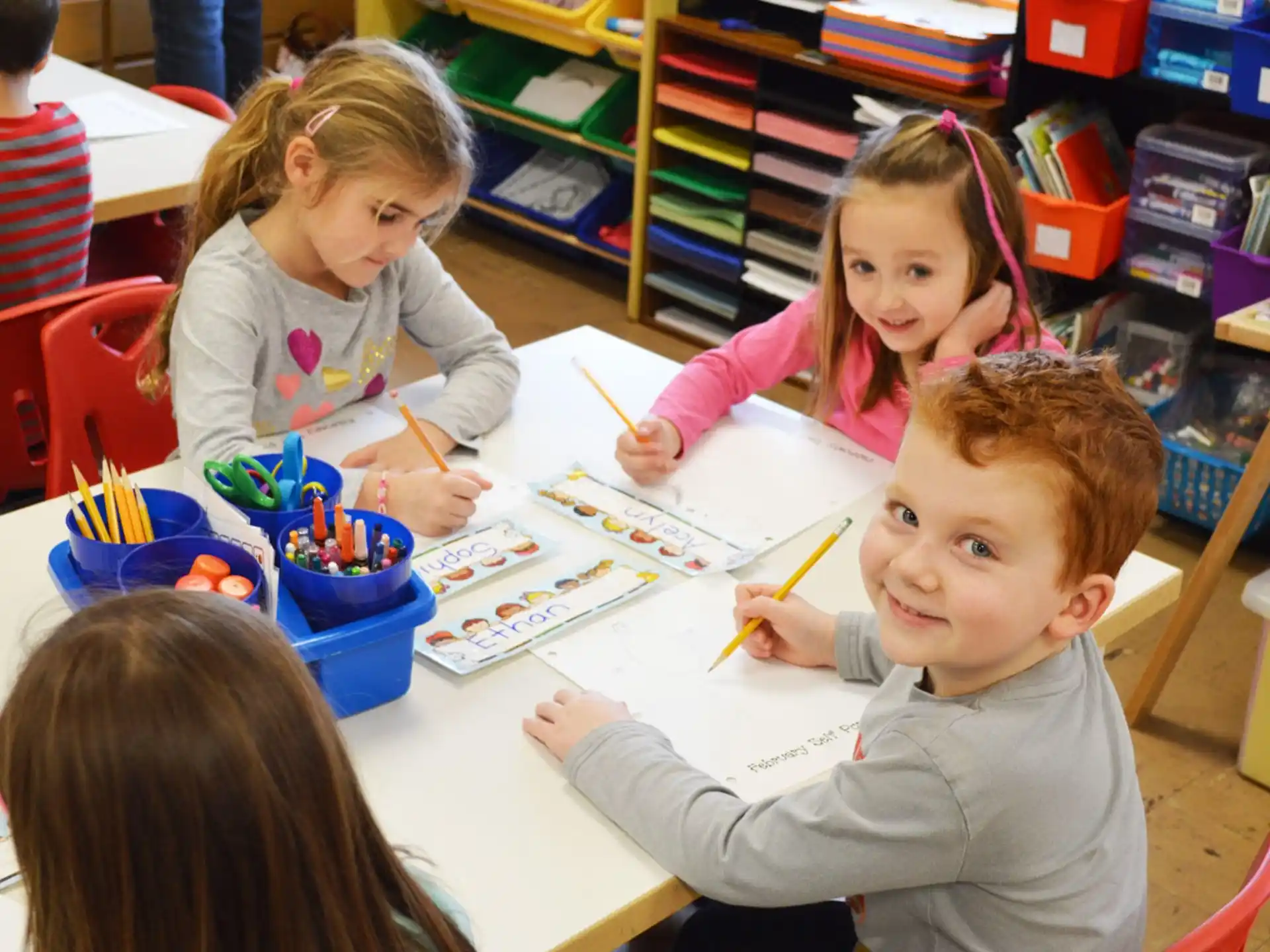 a group of children sitting at a table