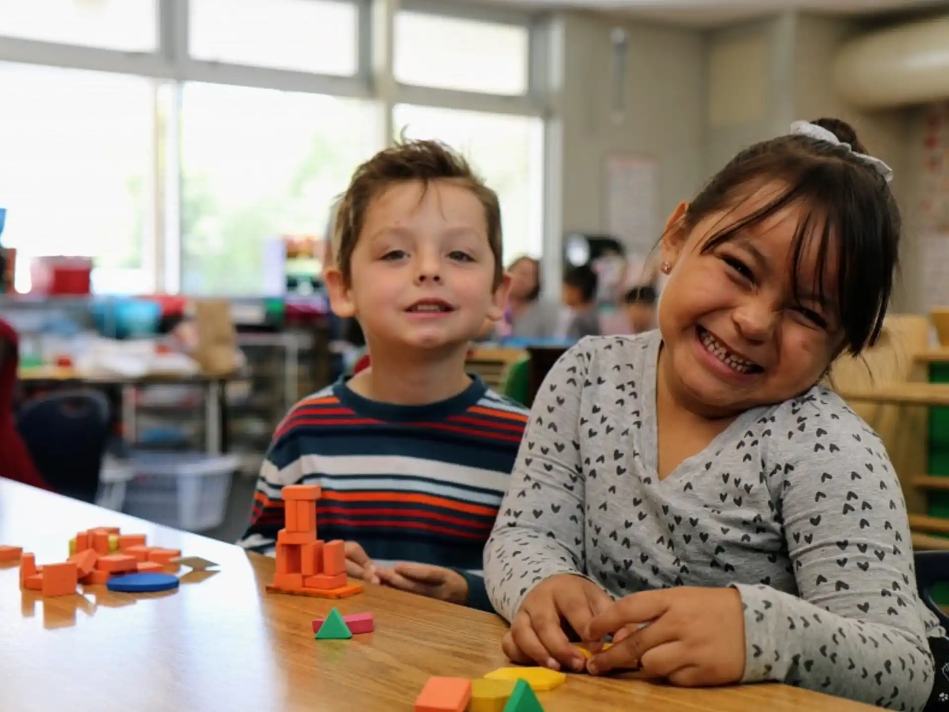 a person and a child sitting at a table