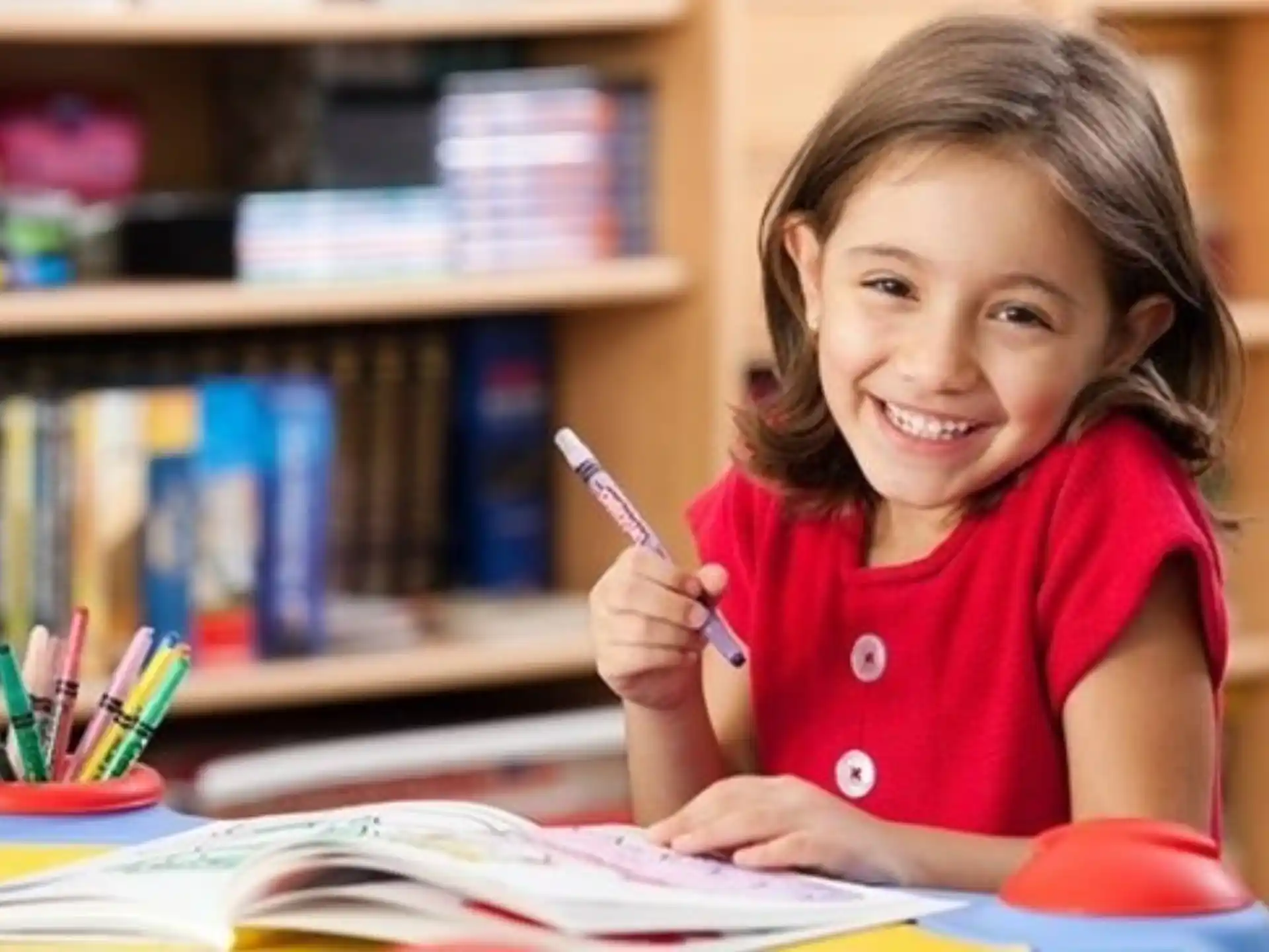 a young girl writing on a book
