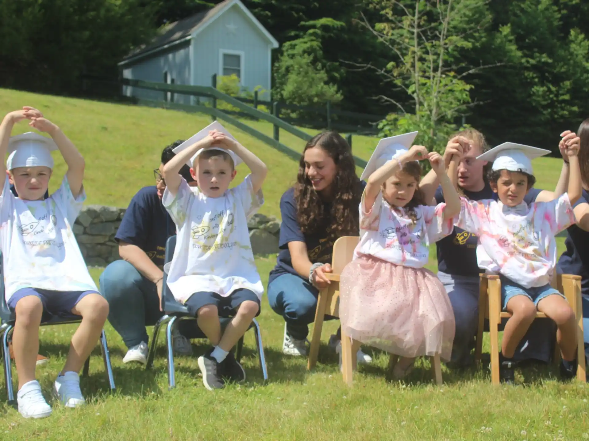 a group of people sitting on the grass