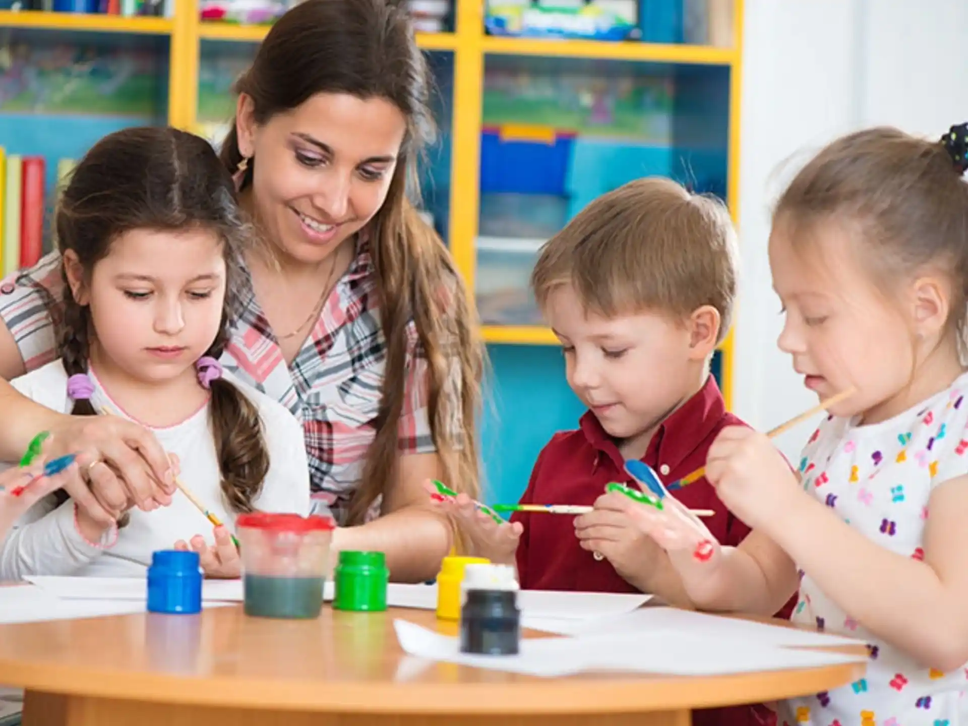 a person and children painting