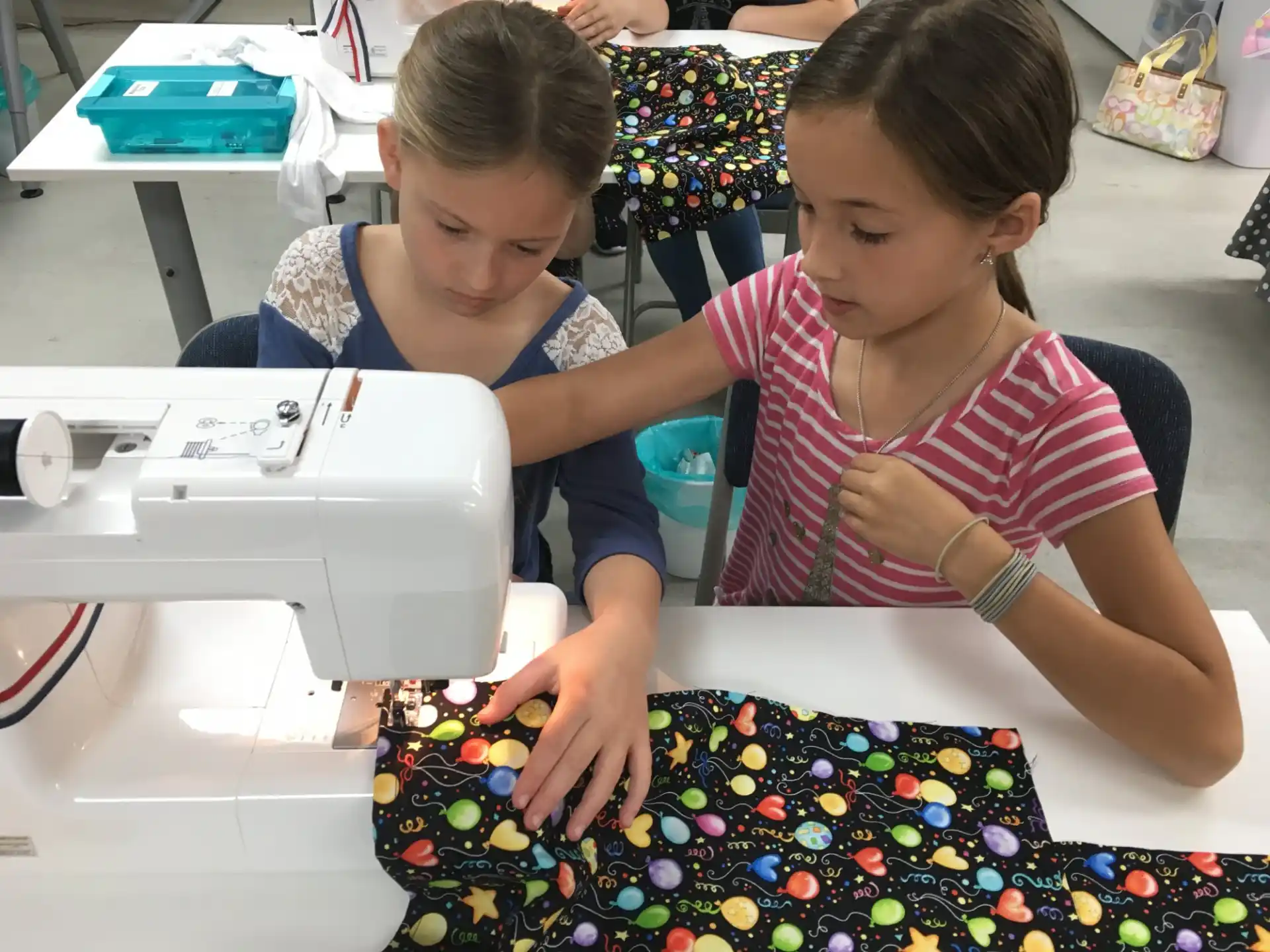 a couple of young girls playing with a toy