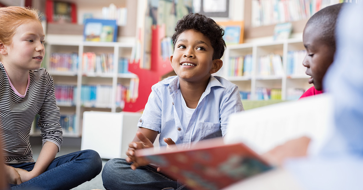 a few children sitting in a library