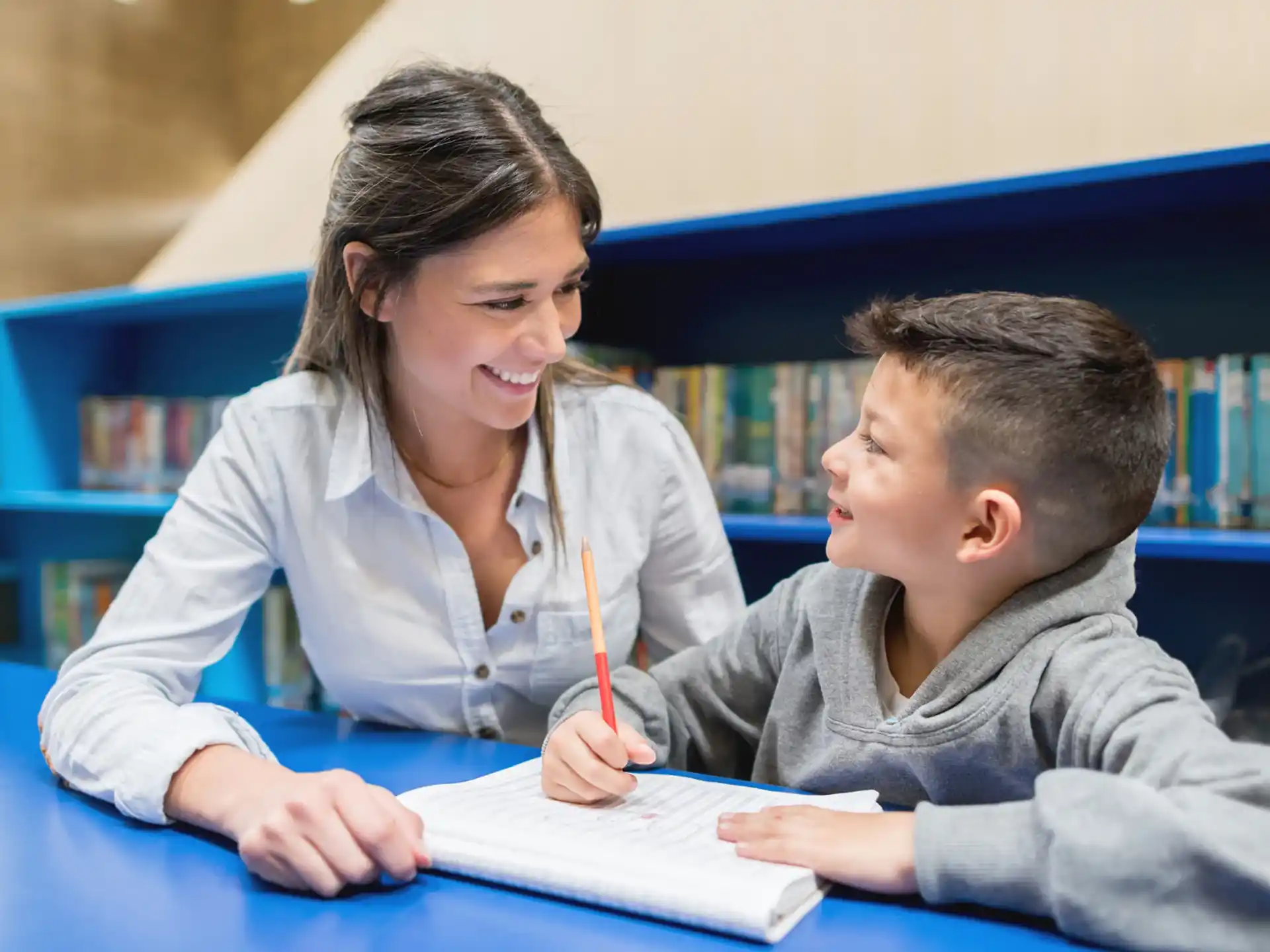 a woman and a boy studying