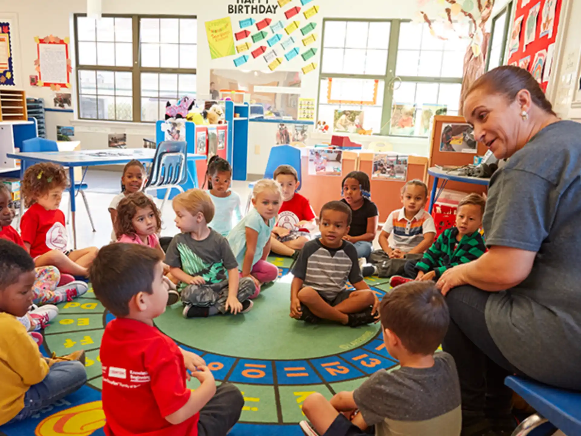 a person and a group of children sitting on the floor