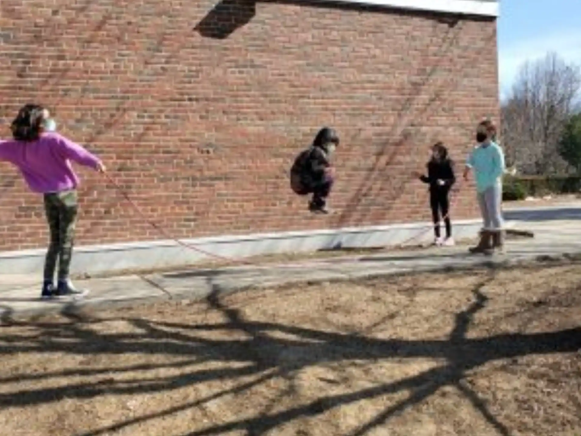 a group of people outside a brick building