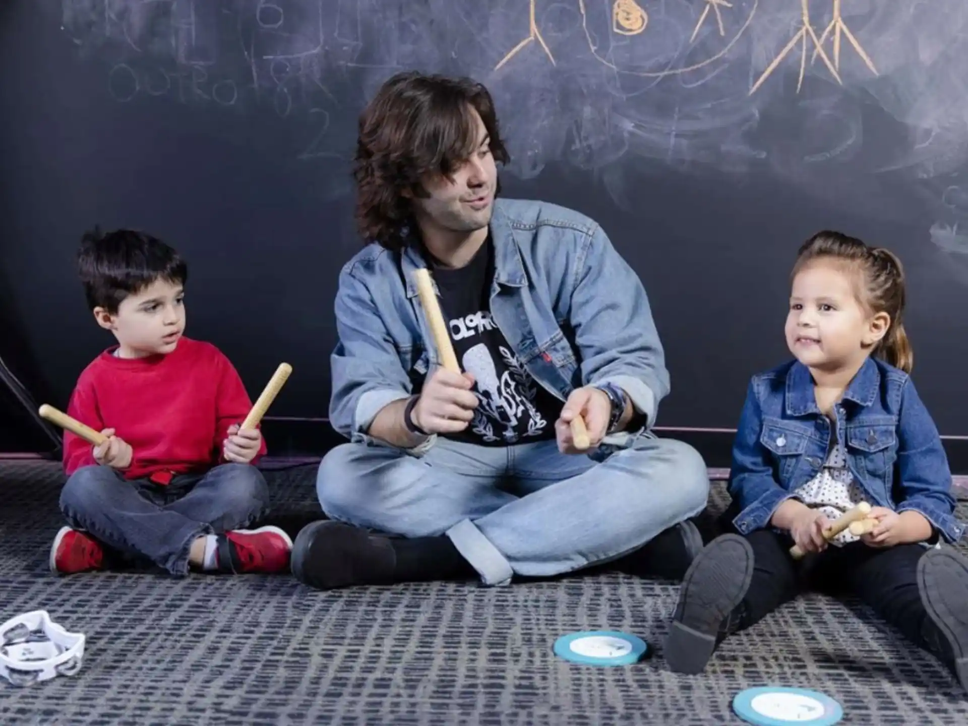 a person and two children sitting on the floor