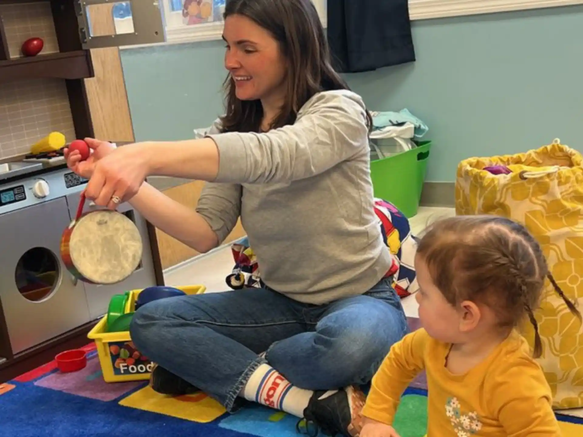 a person and a child playing with toys