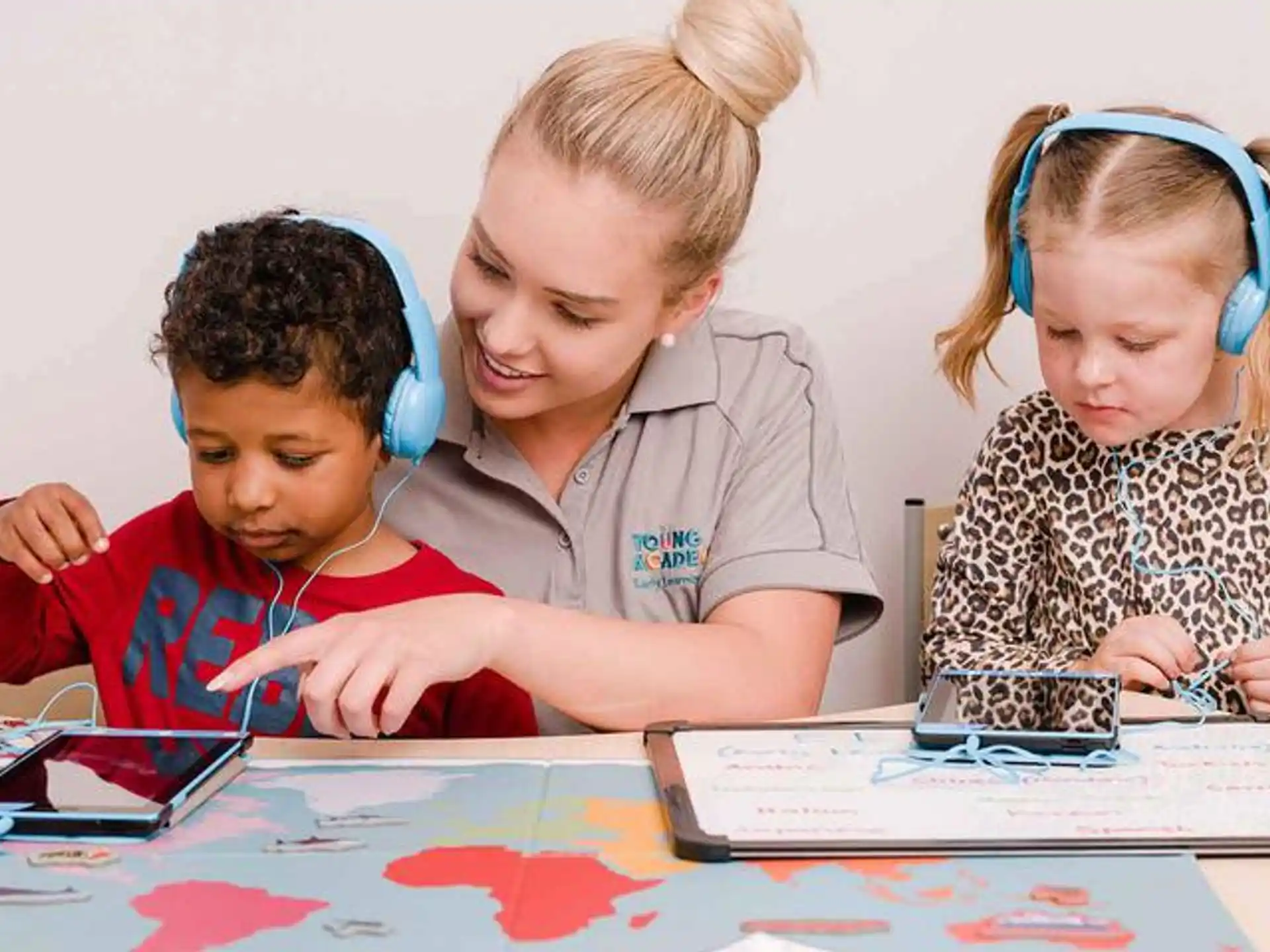 a group of children looking at a map
