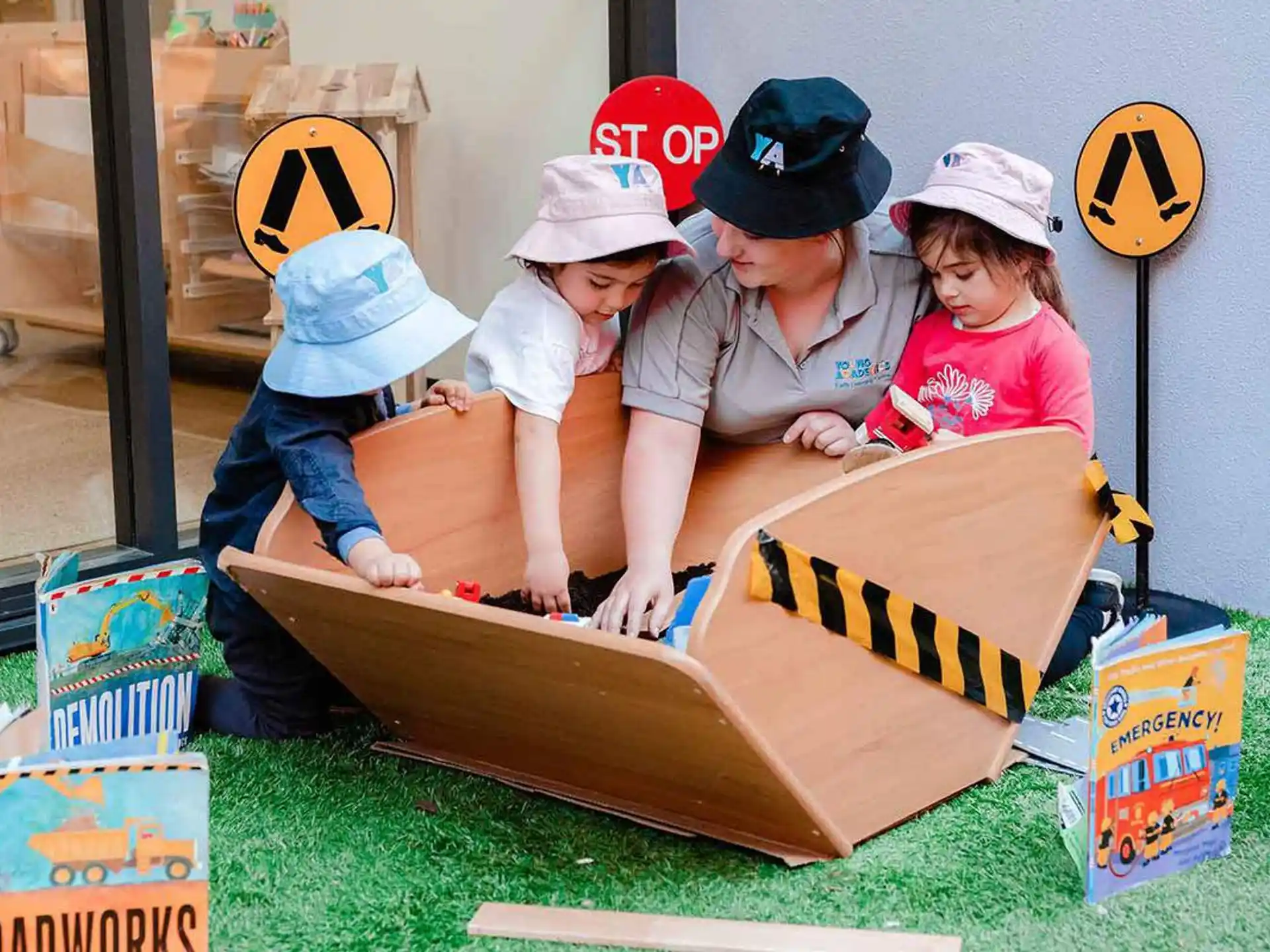 a group of kids playing on a toy train