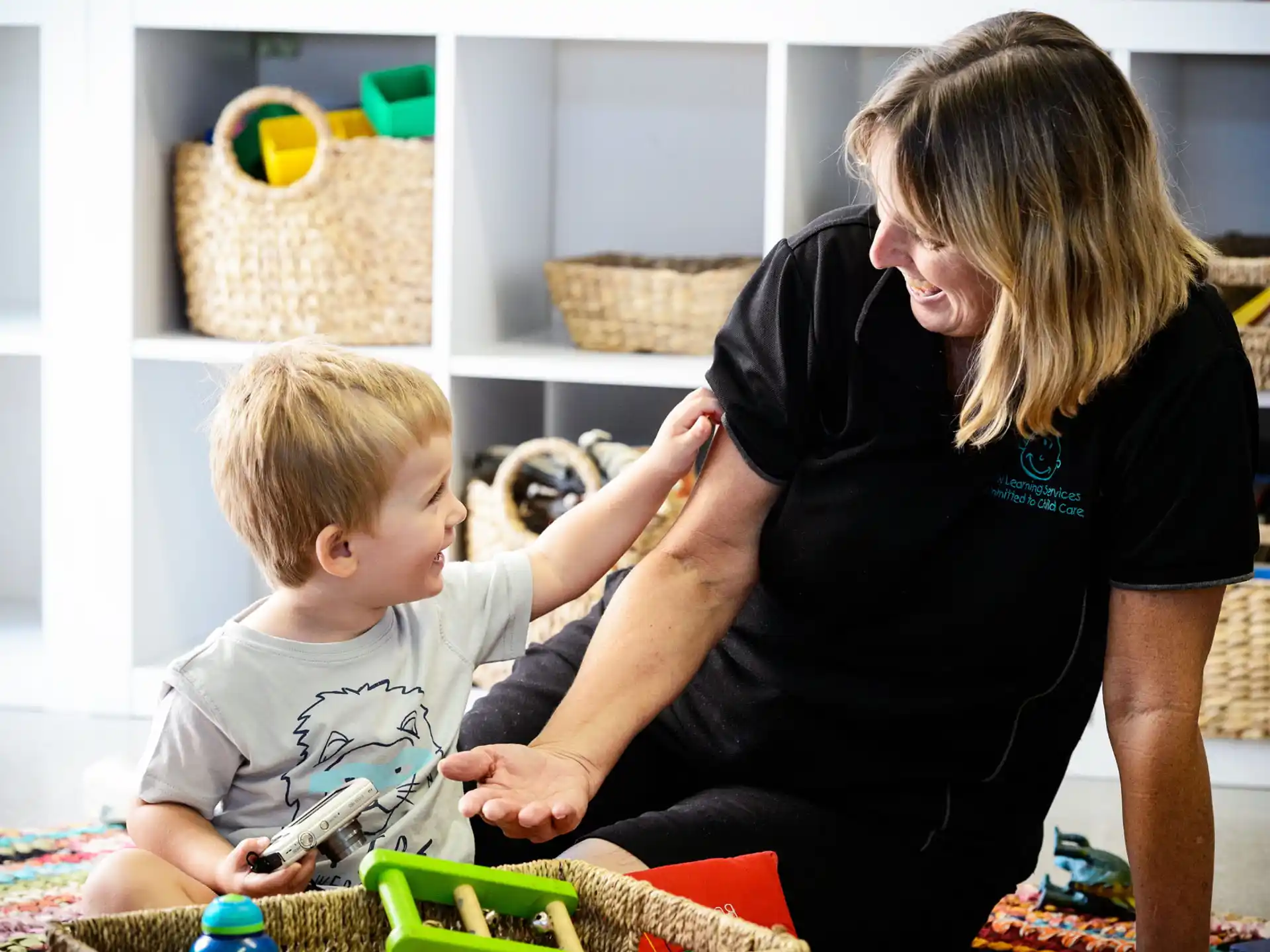 a person and a child playing with toys