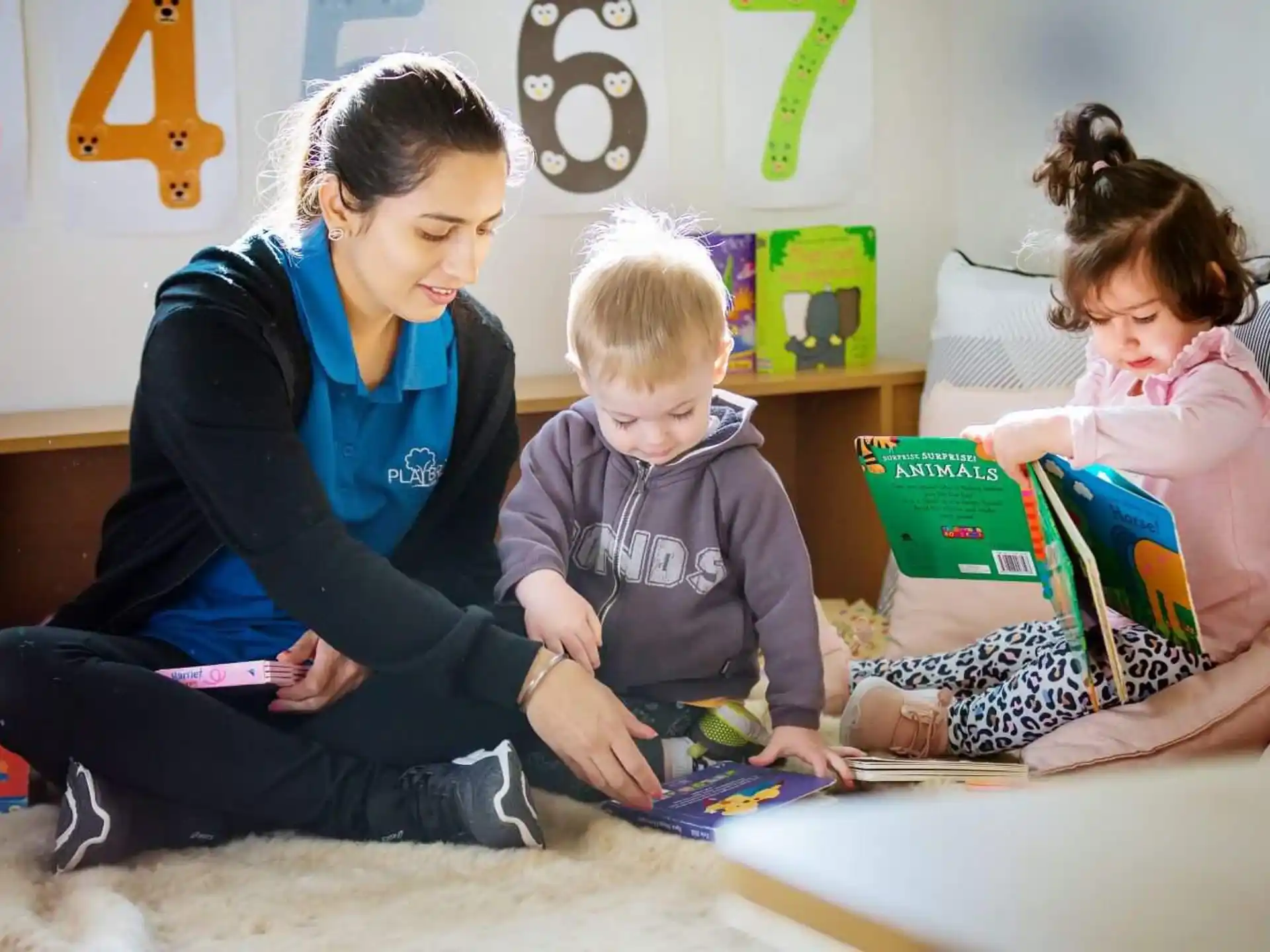 a person and two children reading books