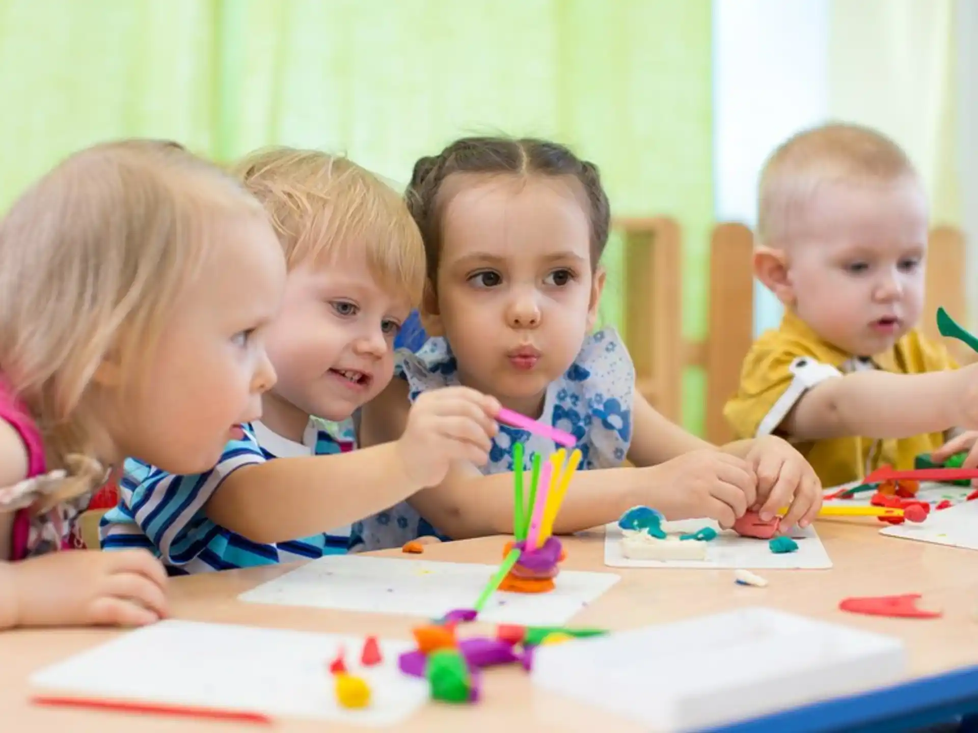 a group of children sitting at a table