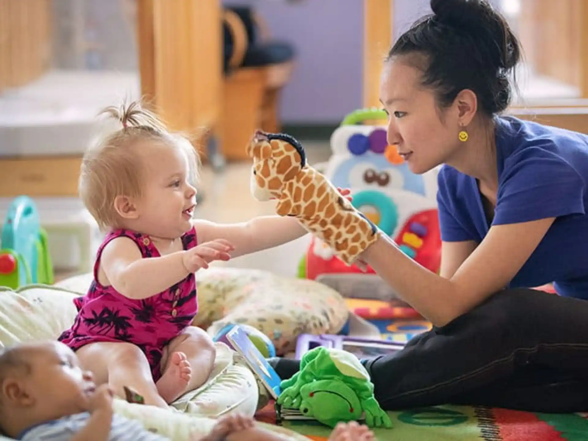 a person and a child playing with a toy