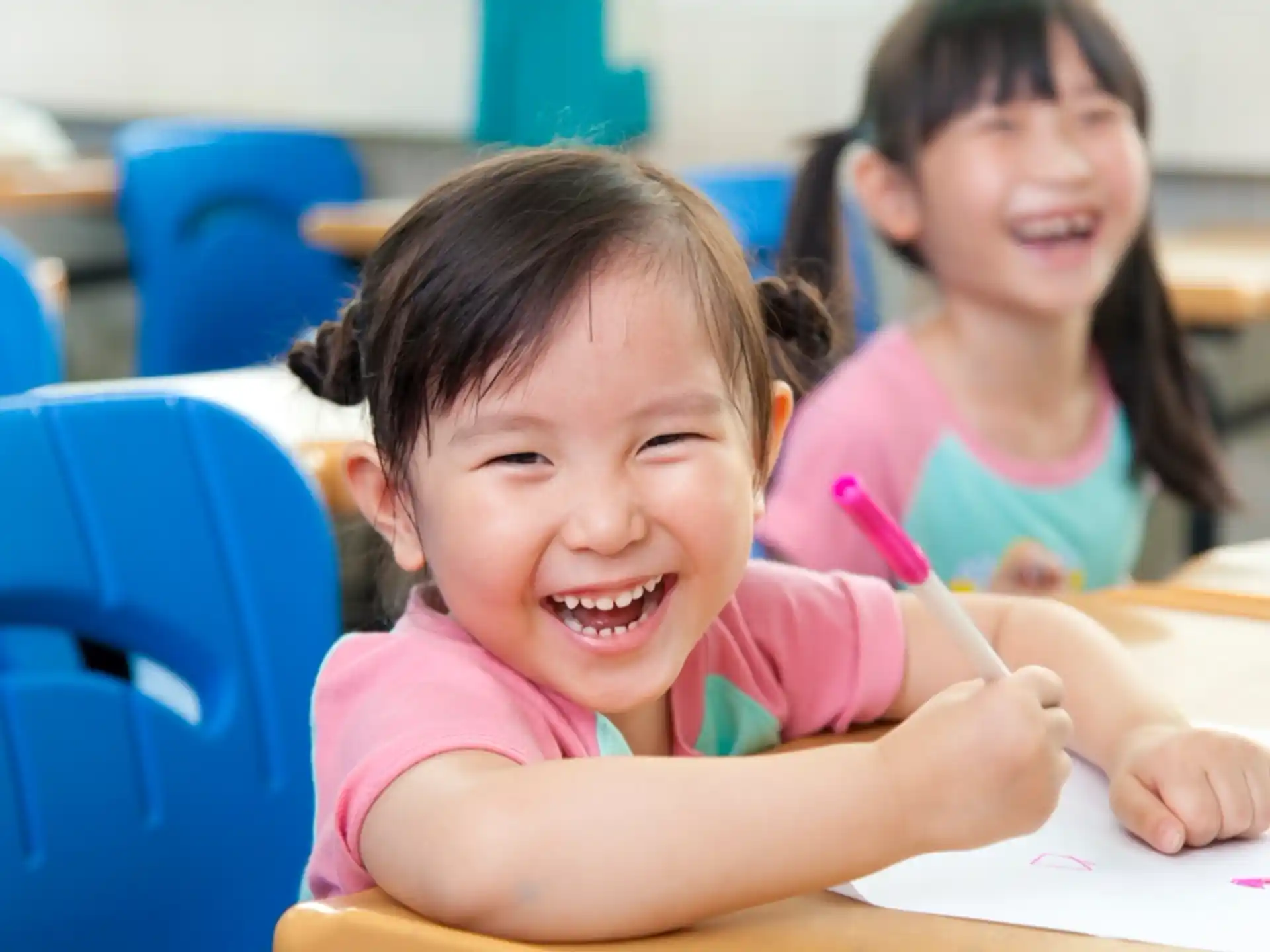 a couple of young girls smiling