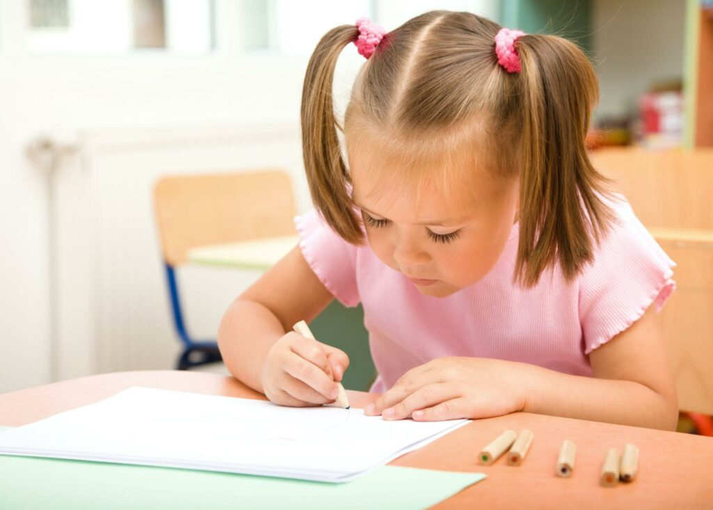 a girl writing on a book