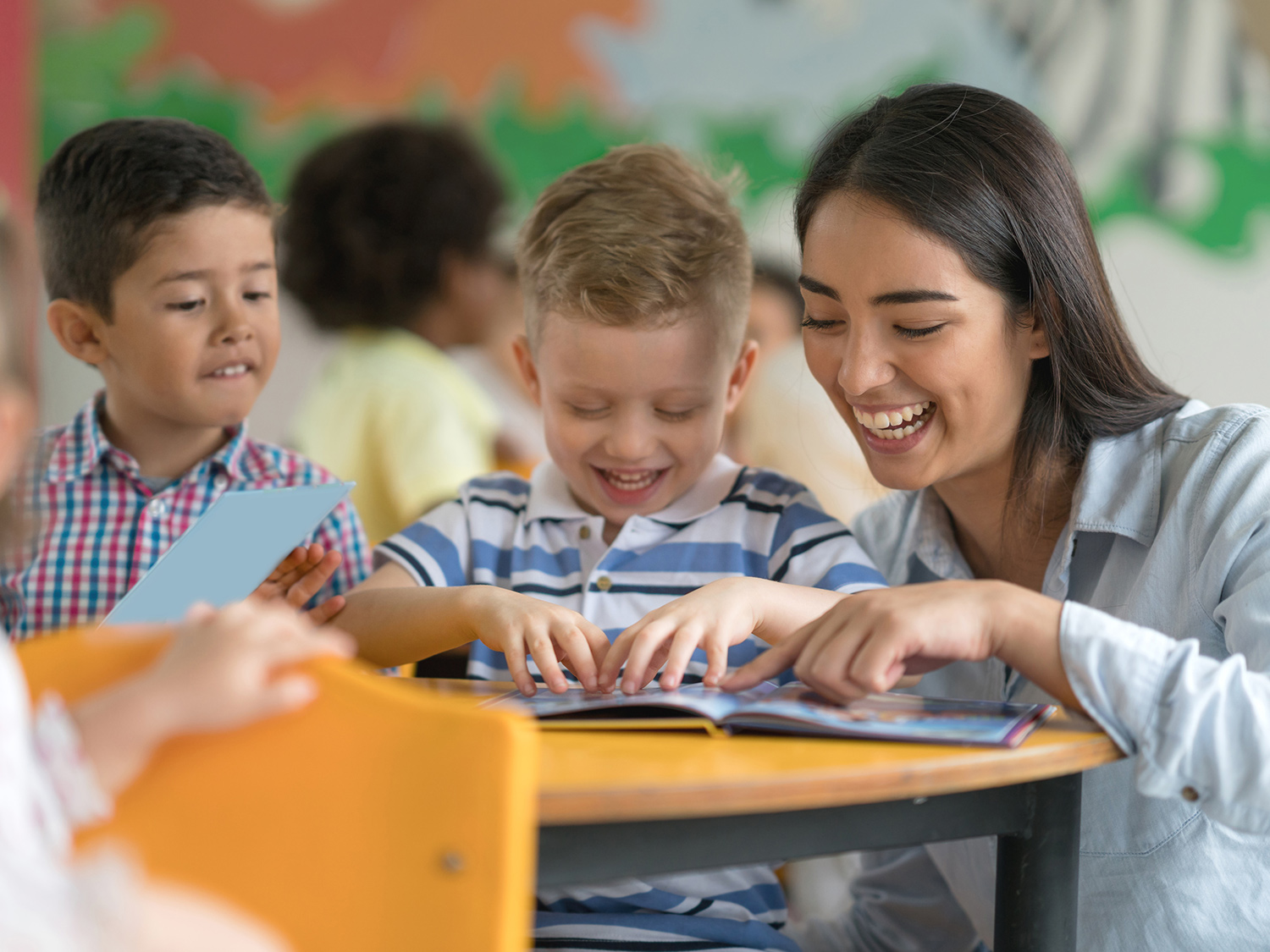a person and several children looking at a computer