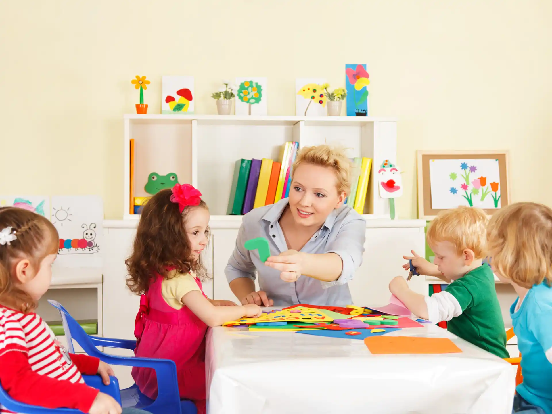 a group of children sitting around a table