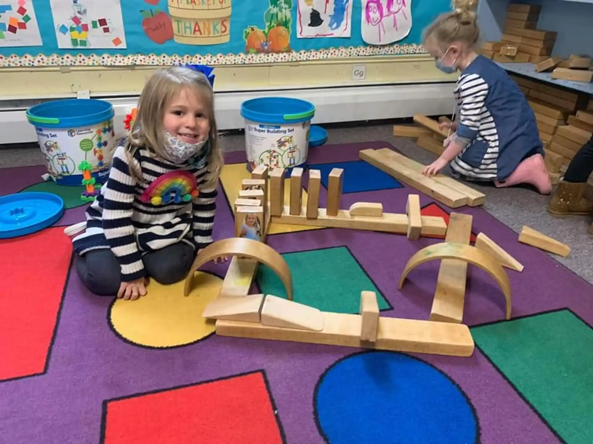 children playing with wooden blocks
