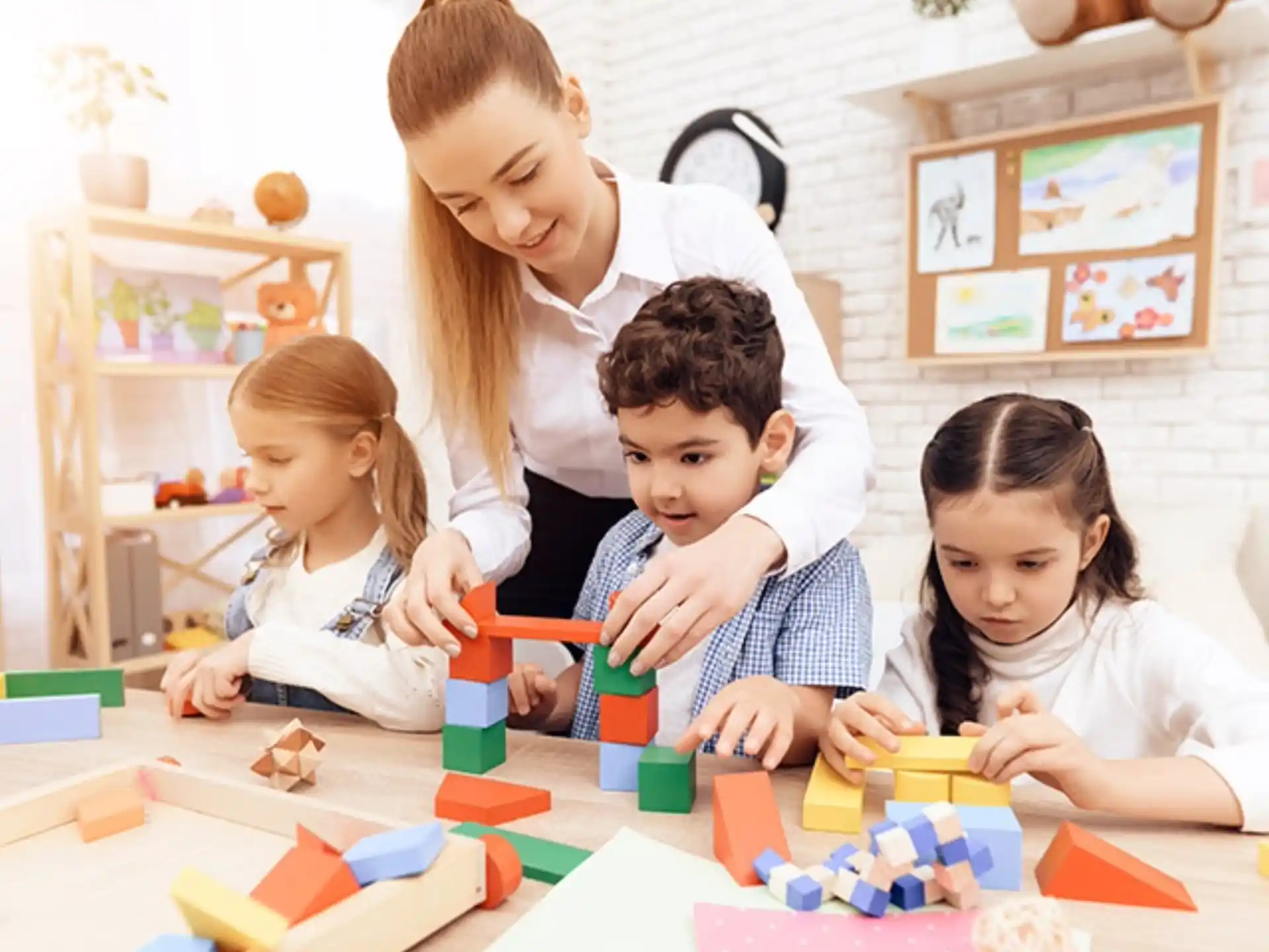 a person and children playing with blocks