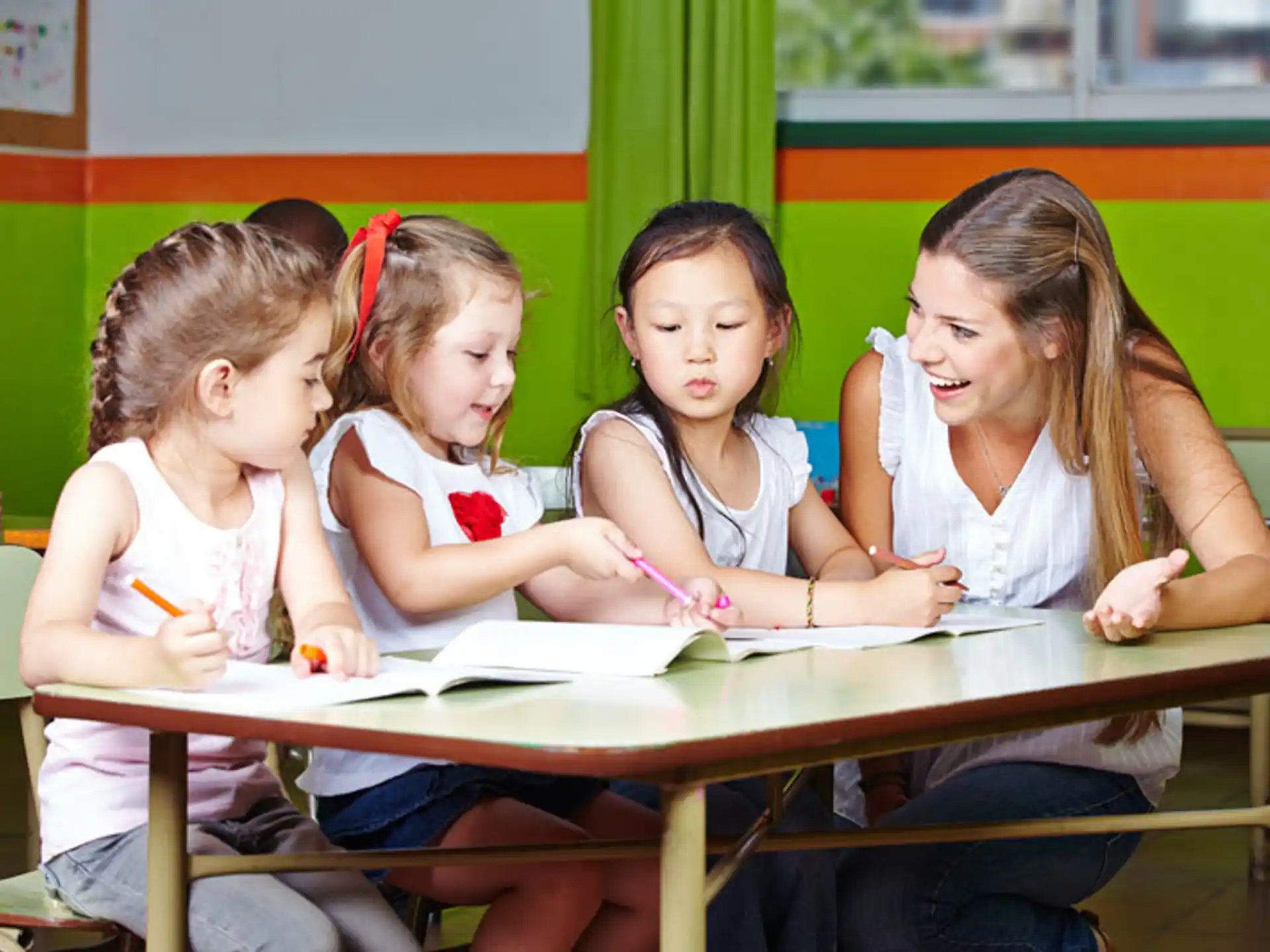 a group of girls sitting at a table