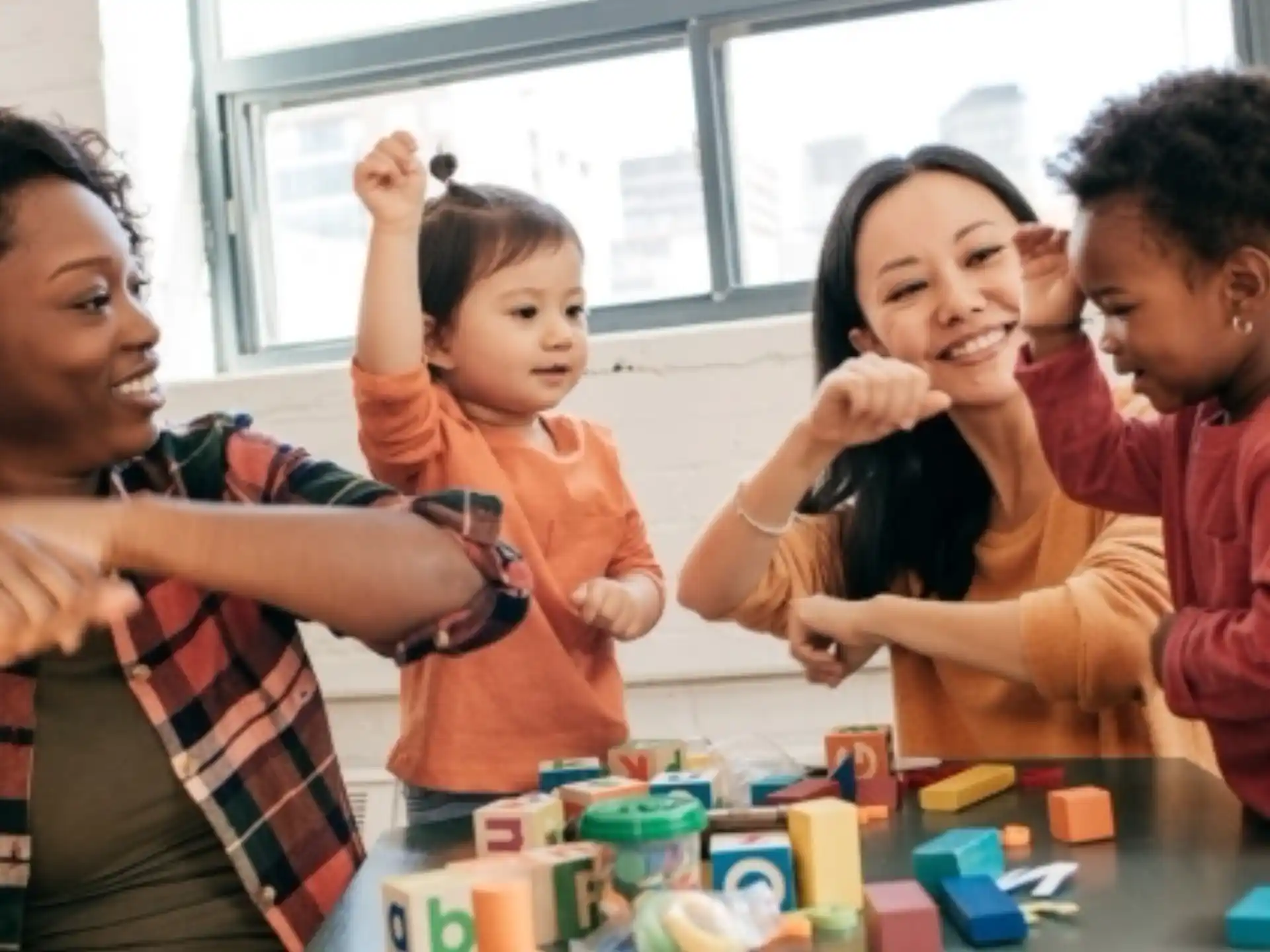 a group of people smiling and playing with toys