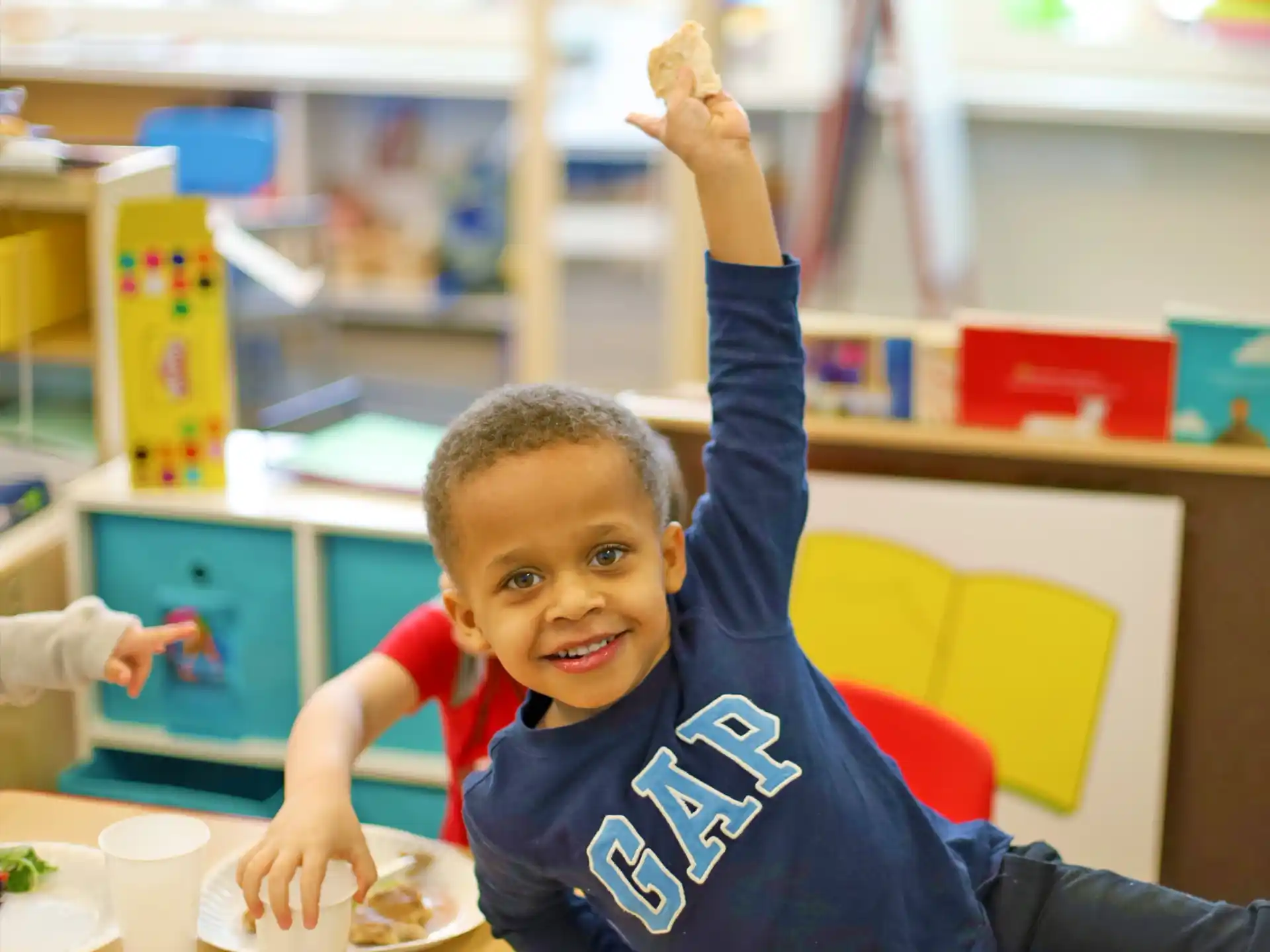 a boy holding up his hands