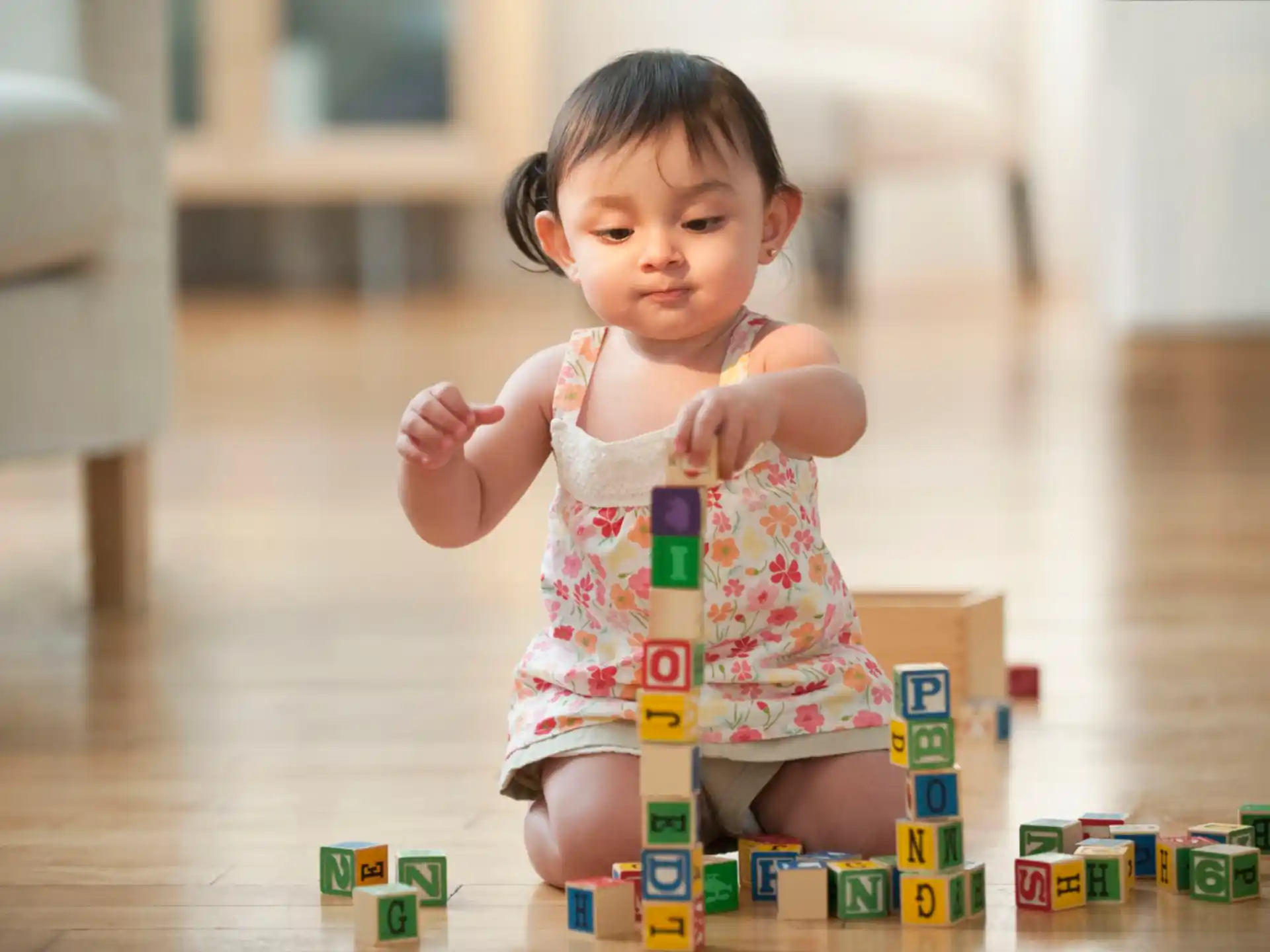 a baby sitting on a floor