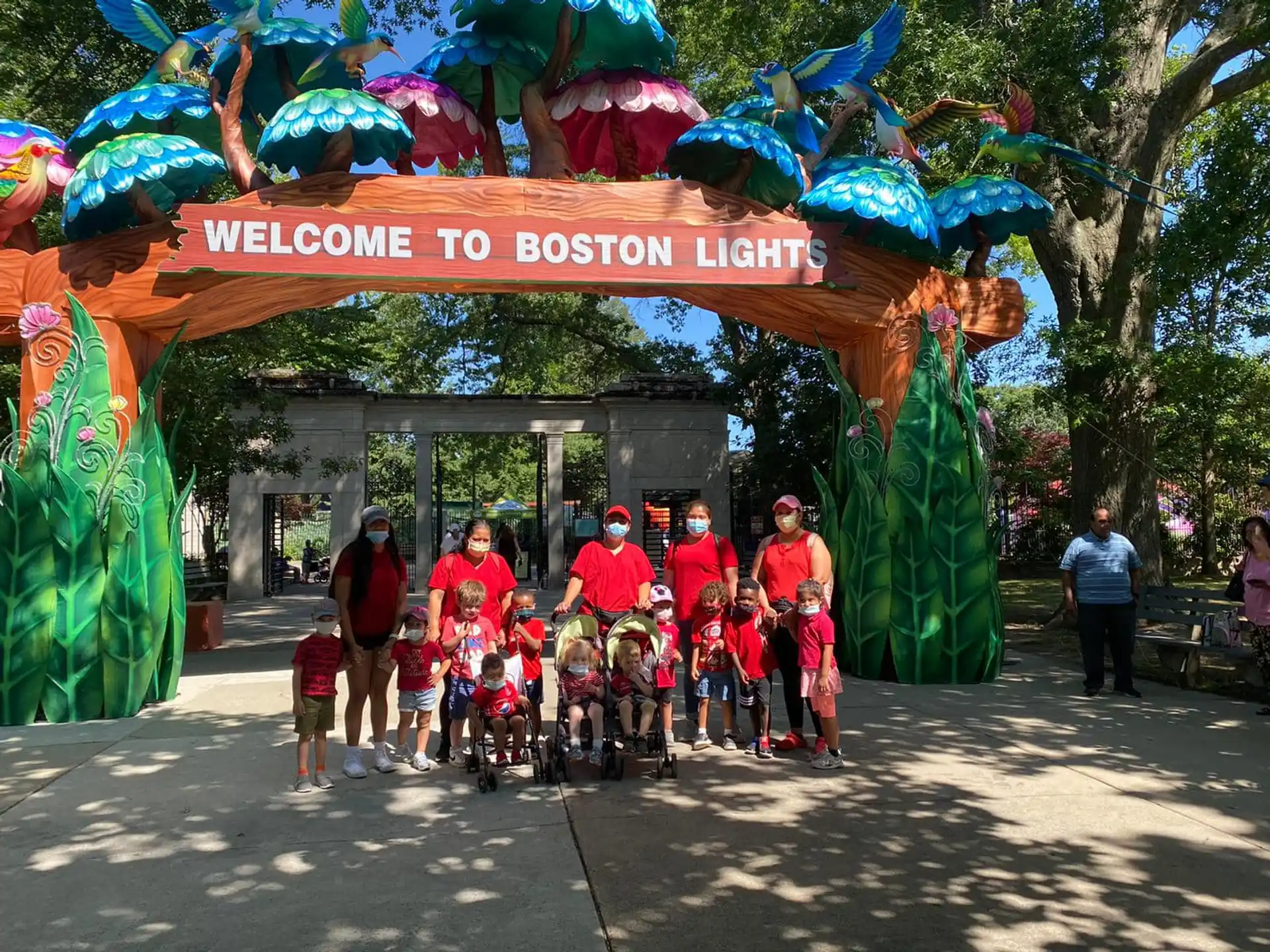 a group of people posing for a photo under a sign