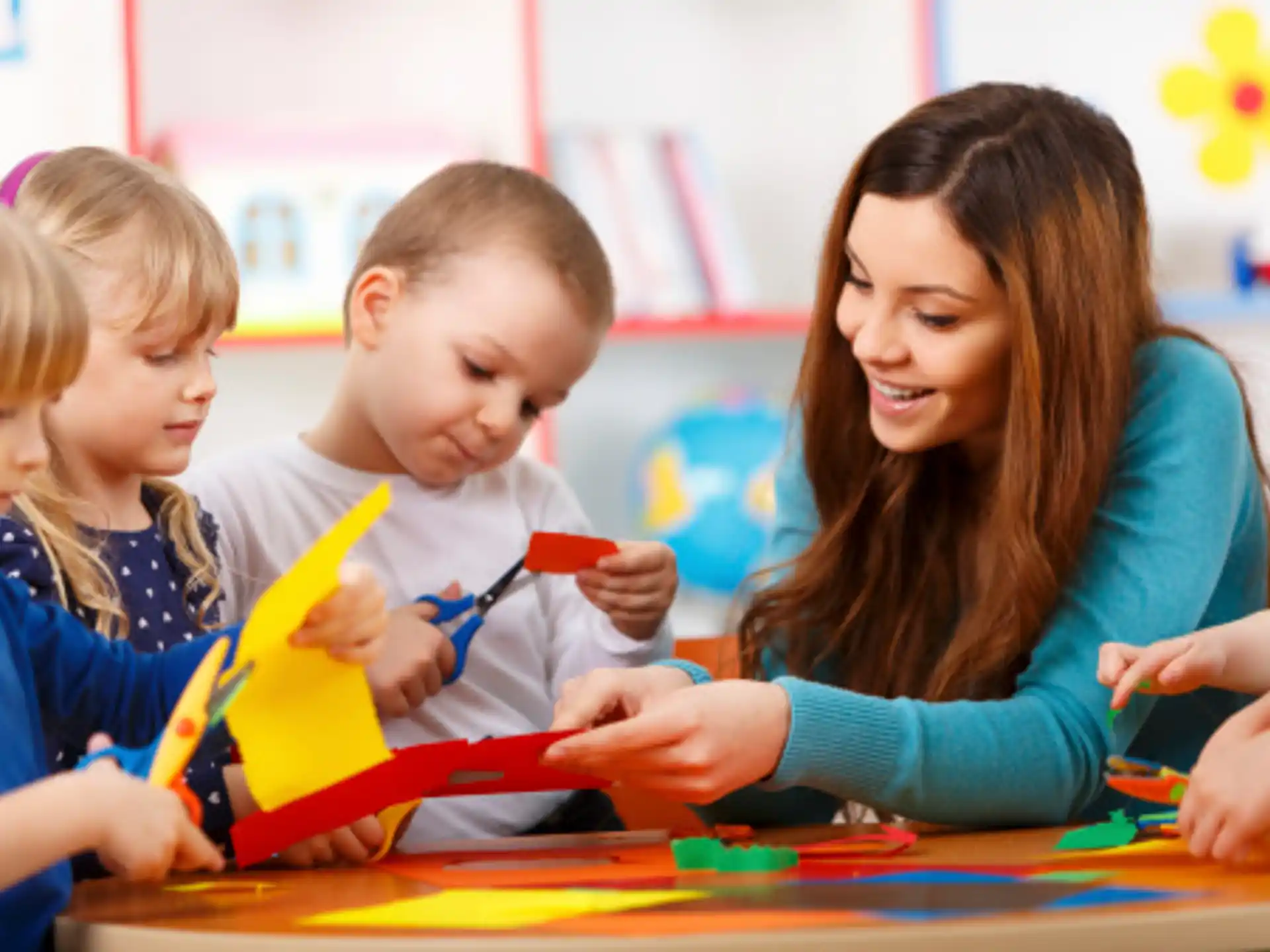 a person and children looking at a book