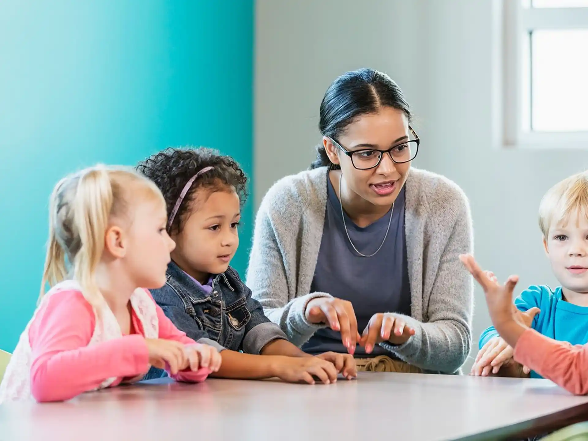 a person and children sitting at a table